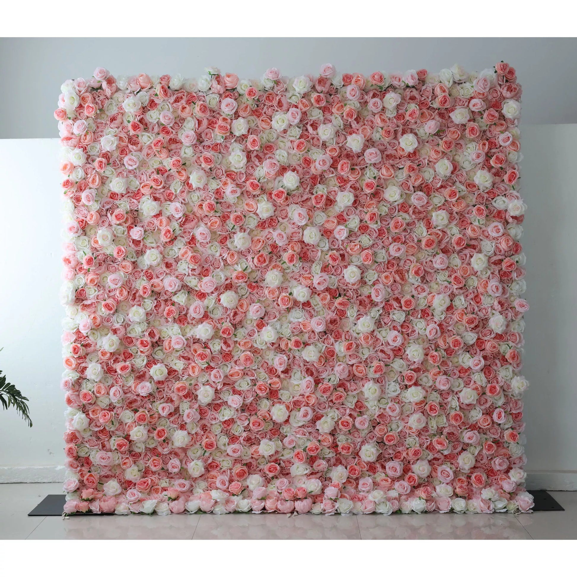 This flower wall is a beautiful blend of pink and white artificial roses. The gradient arrangement creates a soft, romantic vibe, with dense blooms forming a textured, dreamy backdrop. Perfect for weddings or events, it exudes elegance and charm, offering a lovely setting for photos and decor. 
