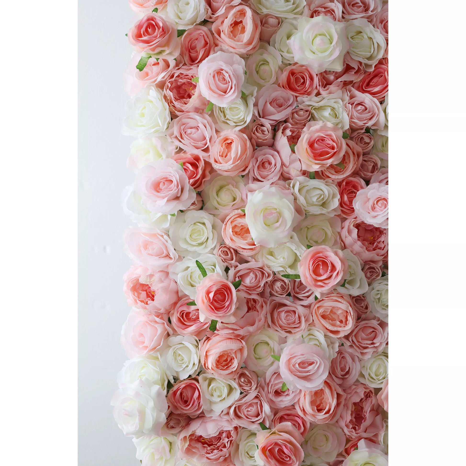 This flower wall showcases a delicate mix of pink and white artificial roses. The blooms are densely packed, with varying petal tones creating a soft, romantic gradient. Small green leaves add subtle contrast, making it perfect for weddings or events. It exudes elegance and charm as a dreamy backdrop. 