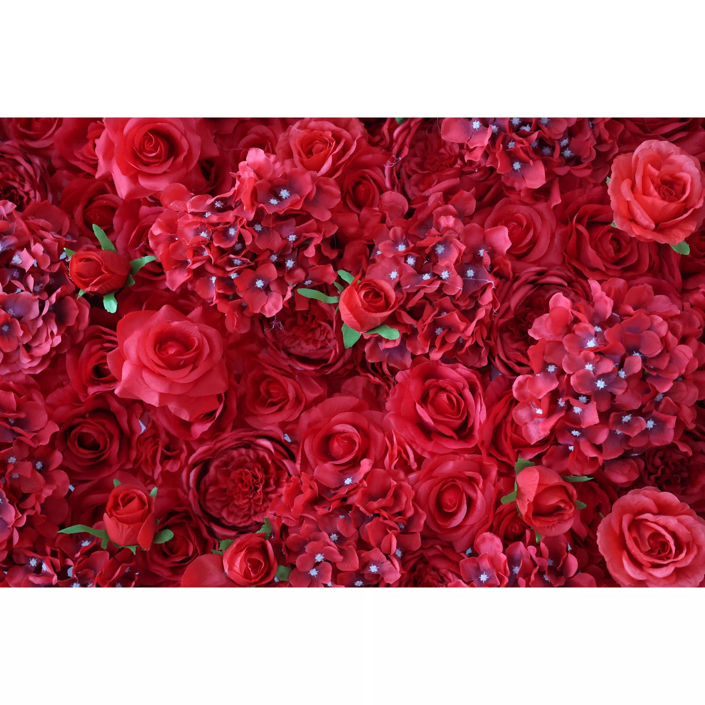 This flower wall is a lavish display of artificial red blooms. It mixes roses, hydrangea - like flowers, and other blossoms, with small white accents and green leaves. The dense, layered arrangement creates a rich, romantic texture, perfect for weddings or elegant events, exuding passion and sophistication. 