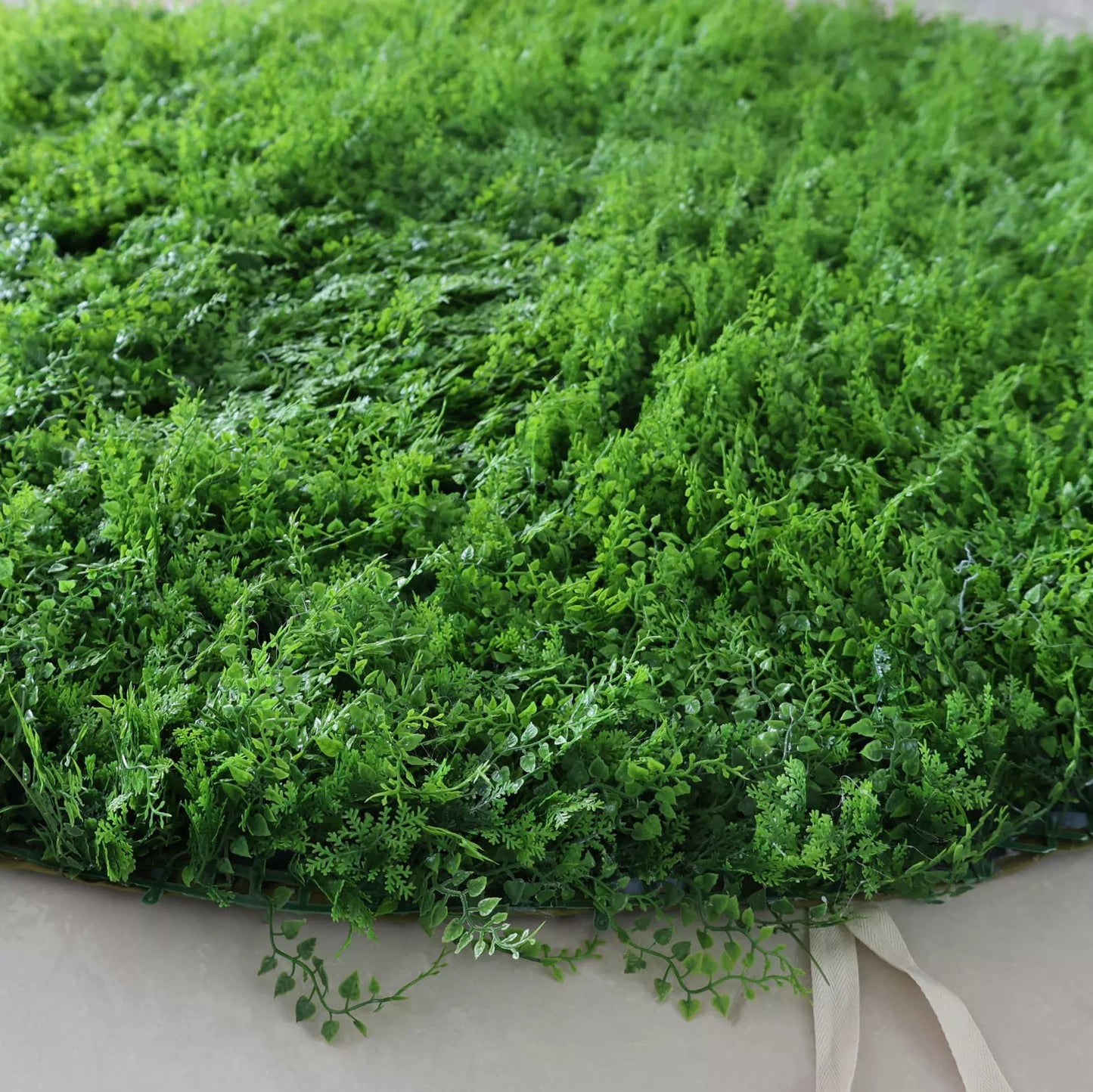 This image showcases a dense artificial greenery piece by Valar Flowers. It features a variety of textured green foliage, creating a rich, natural, and visually refreshing display. With attached straps for easy handling, this product is perfect for adding a touch of organic elegance to events or spaces, exuding a serene and sophisticated atmosphere characteristic of Valar Flowers’ craftsmanship.