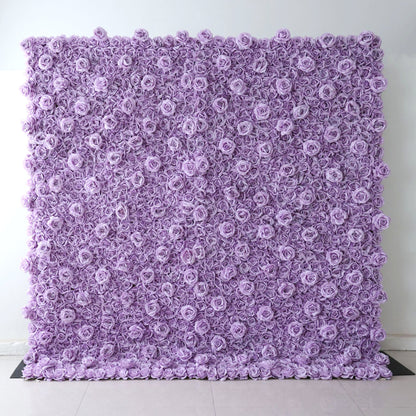 A square Valar Flowers floral wall panel, fully assembled against a plain white wall on light tile flooring, is entirely covered in dense, uniform lavender fabric roses. The seamless, textured design delivers a sleek, monochromatic aesthetic, perfect for minimalist weddings, baby showers, or purple-themed event photo backdrops.