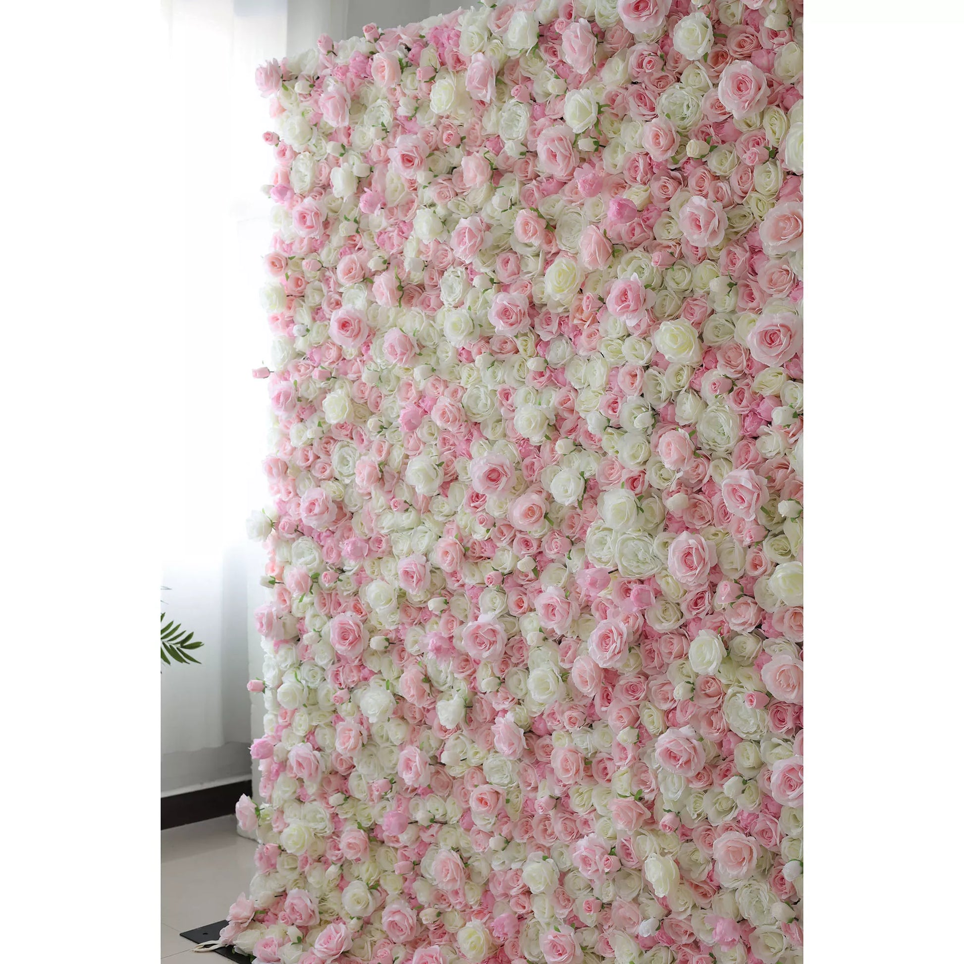 This is a large, rectangular artificial flower wall backdrop, densely covered with a lush mix of soft pink, white, and pale green roses and peonies. It stands upright indoors against a plain white wall, creating a romantic, elegant, and dreamy display perfect for weddings, photo shoots, or special events.