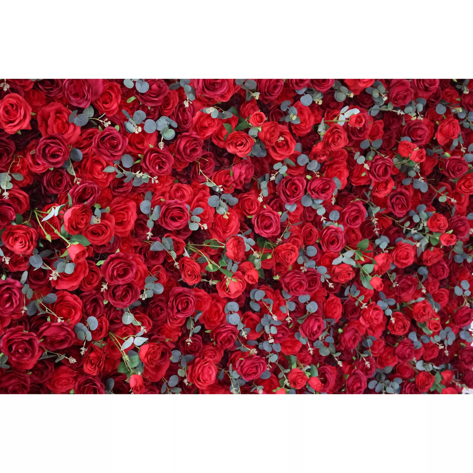 This flower wall is a lavish display of artificial red roses, interspersed with eucalyptus leaves. The dense, uniform arrangement creates a rich, passionate texture. Perfect for events needing a dramatic, romantic backdrop, exuding elegance and intensity. A striking centerpiece for weddings or celebrations. 