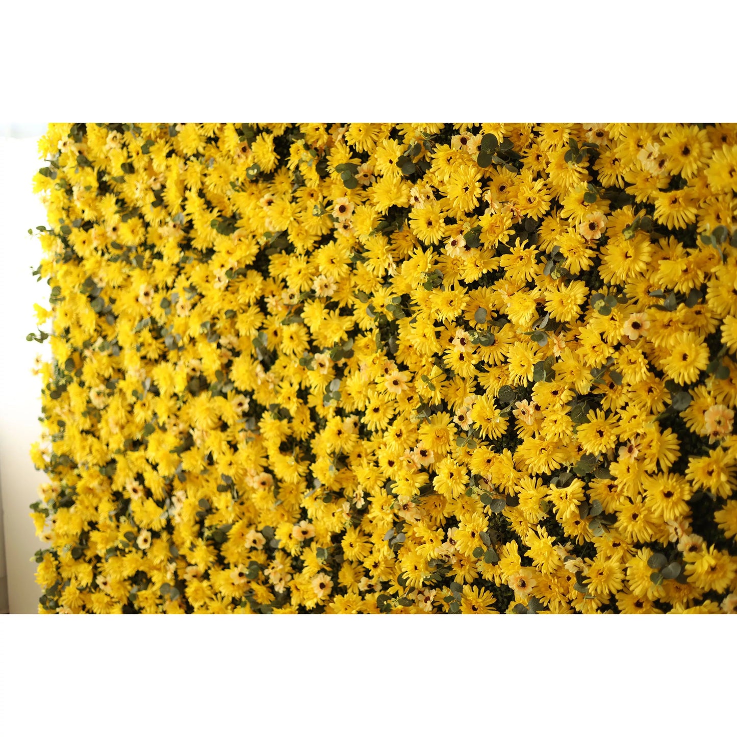 This intimate close-up showcases a dense, textured arrangement of artificial yellow daisies with dark centers, layered with subtle green foliage. The bold, sun-drenched palette creates a cheerful, energy-filled effect that exudes warmth and joy. It serves as a lively backdrop for summer events, photoshoots, or spaces seeking a bright, uplifting aesthetic.
