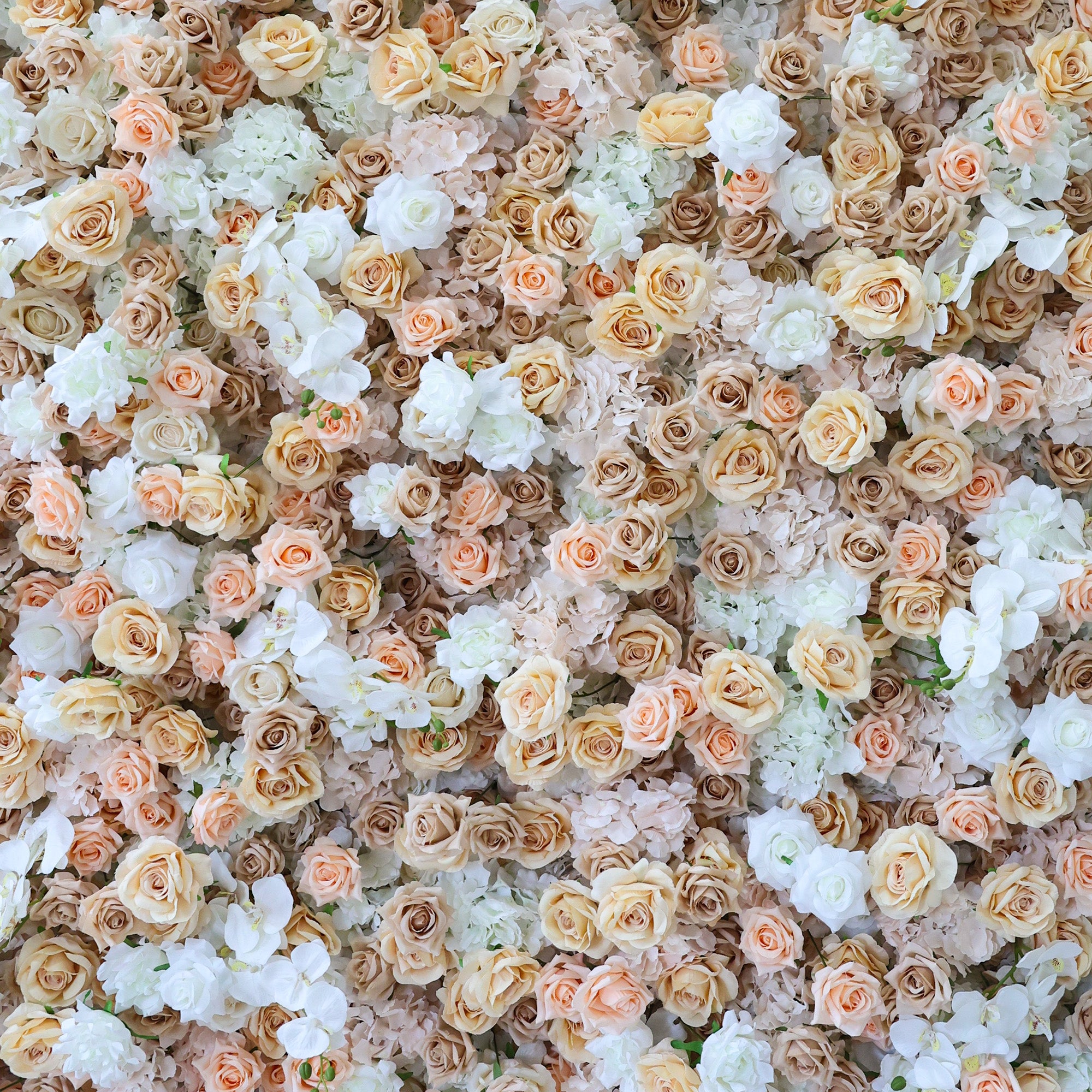 This image displays a dense, vibrant arrangement of artificial flowers in soft hues of beige, peach, and white. The flowers, including roses and other blooms, are clustered tightly to form a lush, romantic floral tapestry. The harmonious color palette and intricate petals create an elegant, charming scene, ideal for event decor or as a visually appealing artistic display.