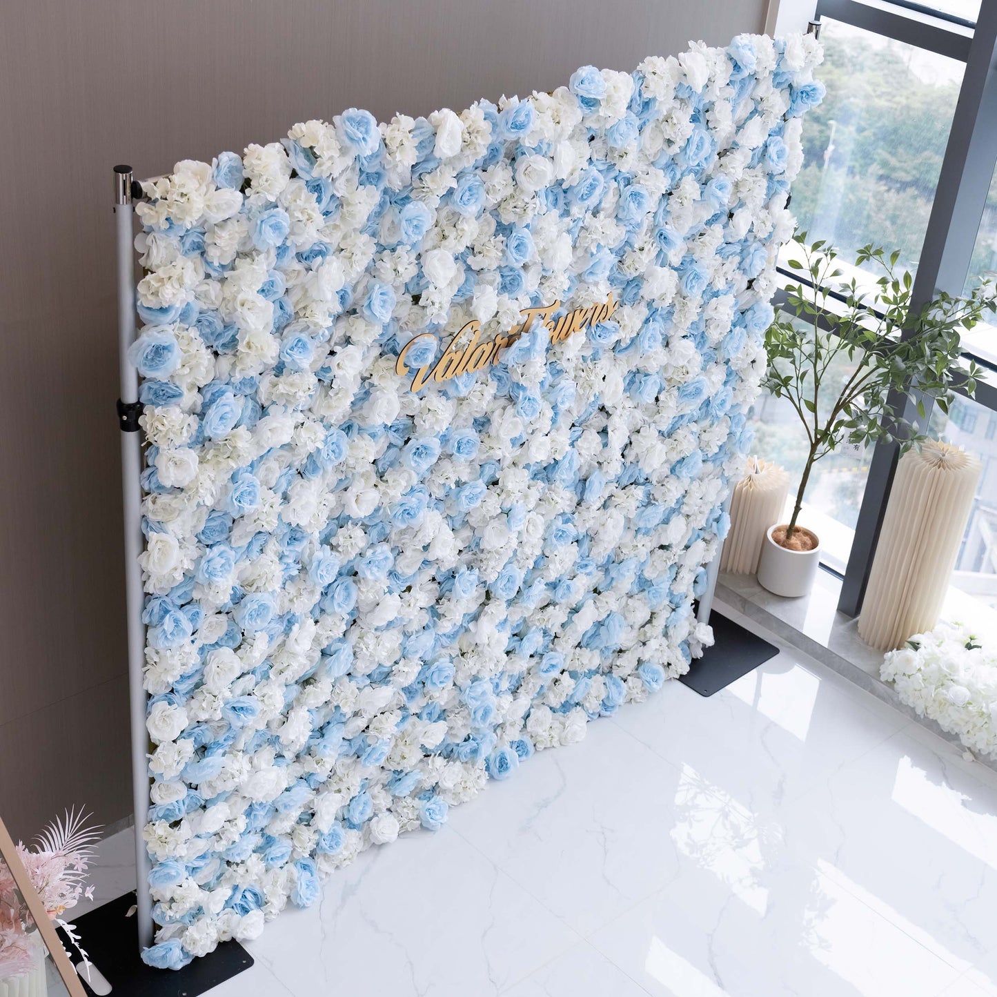 ValarFlowers' artificial flower wall is a wedding dream. With its beautiful blend of blue and white flowers, it creates a romantic and elegant backdrop, perfect for capturing precious wedding memories.