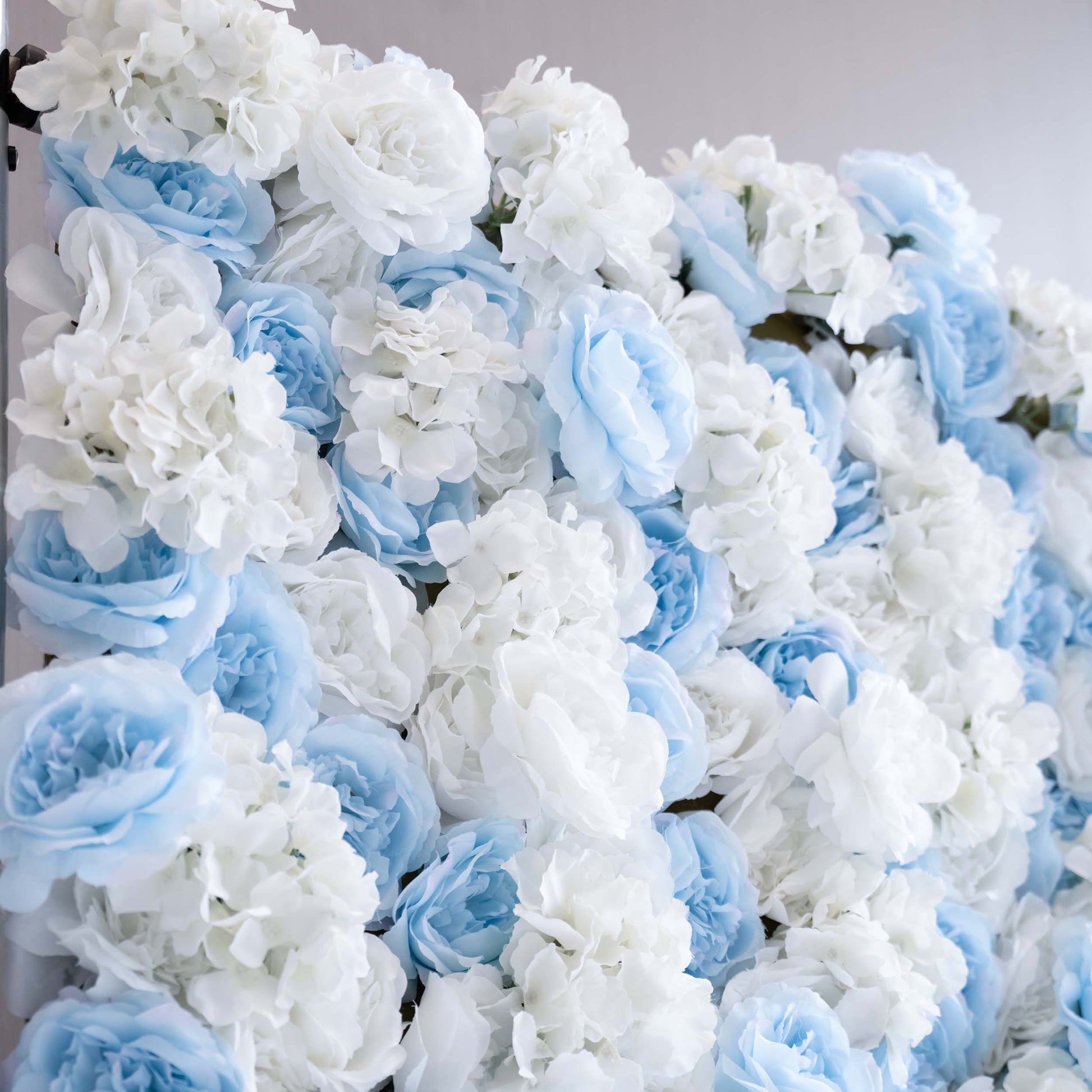 ValarFlowers' artificial flower wall is perfect for weddings. It features a beautiful blend of blue and white flowers, creating a romantic and elegant backdrop for the special day.