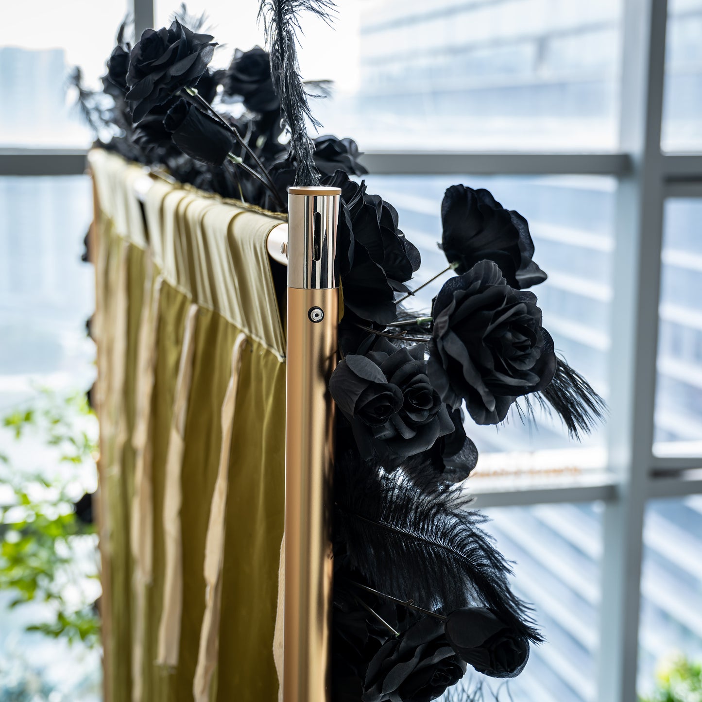 The image shows a section of a luxurious black rose wall with the brand name "ValarFlowers" prominently displayed. The wall is adorned with feathers at the edges, creating a dramatic and elegant look.