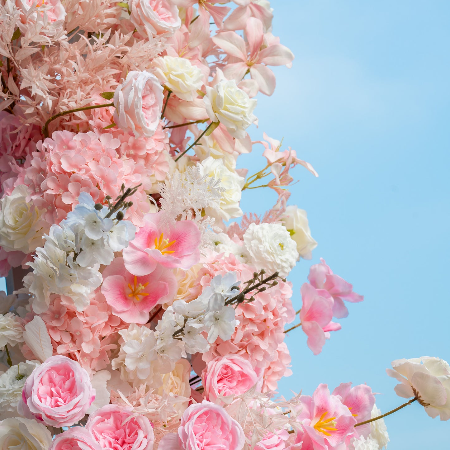 This backdrop features a lush arrangement of artificial flowers. It includes roses in various shades of pink and white, pink hydrangeas, and delicate white and light - pink blossoms. The color palette is soft and pastel - toned, with a mix of pinks, whites, and hints of blue. The style is romantic and elegant, perfect for wedding or bridal events. 