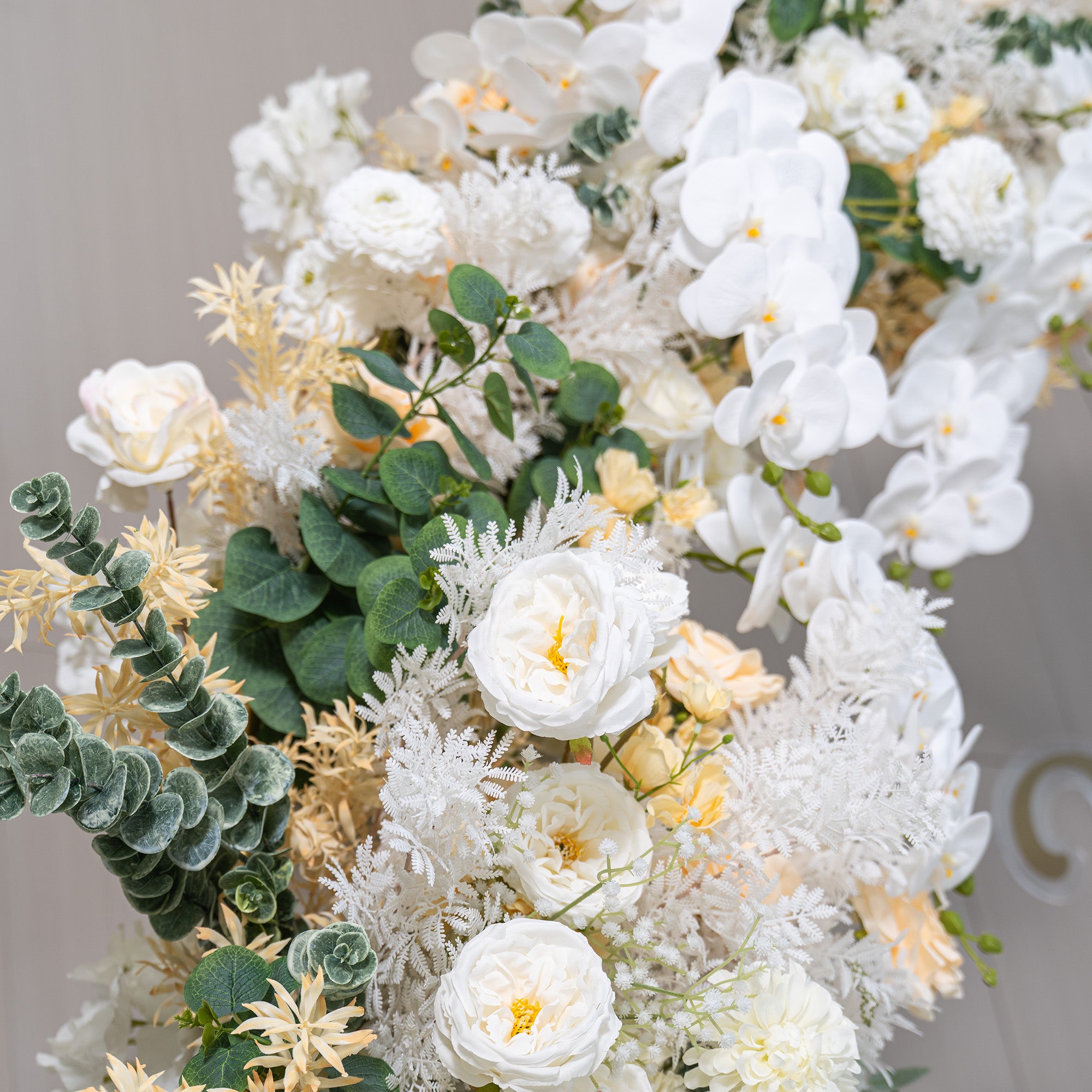 This backdrop showcases a lush arrangement of artificial flowers. It prominently features white phalaenopsis orchids, white roses, and white chrysanthemums. Accents include soft - yellow roses and green eucalyptus leaves. The color palette is dominated by whites and creams, with touches of green. The style is elegant and serene, ideal for sophisticated events. 