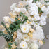 This backdrop showcases a lush arrangement of artificial flowers. It prominently features white phalaenopsis orchids, white roses, and white chrysanthemums. Accents include soft - yellow roses and green eucalyptus leaves. The color palette is dominated by whites and creams, with touches of green. The style is elegant and serene, ideal for sophisticated events. 
