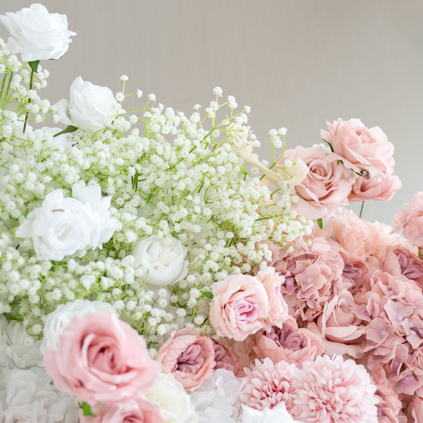 This backdrop features a charming arrangement of artificial flowers. Prominent flowers include white roses, soft - pink roses, and clusters of baby's breath. The color palette is a gentle blend of whites, light pinks, and hints of green from the foliage. The style is delicate and romantic,  ideal for creating a dreamy and elegant atmosphere at bridal or wedding events. 