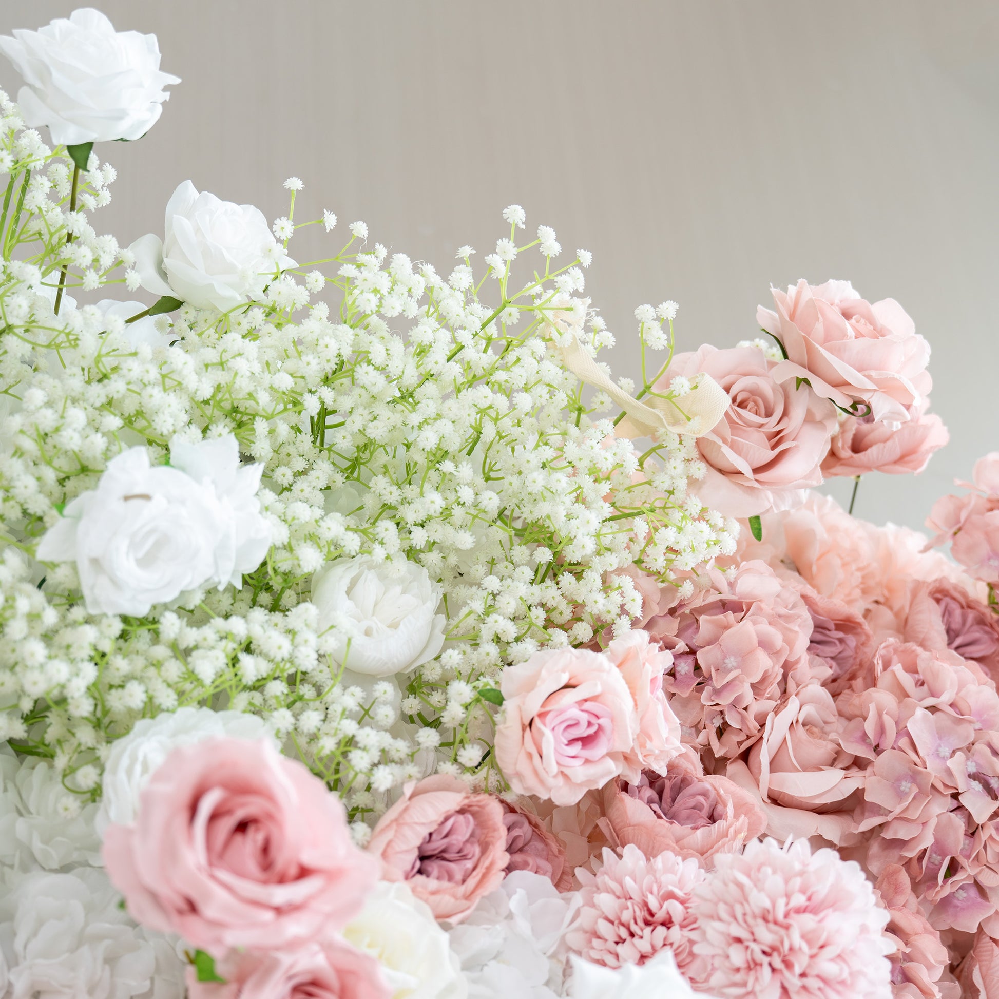 This backdrop features a charming arrangement of artificial flowers. Prominent flowers include white roses, soft - pink roses, and clusters of baby's breath. The color palette is a gentle blend of whites, light pinks, and hints of green from the foliage. The style is delicate and romantic,  ideal for creating a dreamy and elegant atmosphere at bridal or wedding events. 
