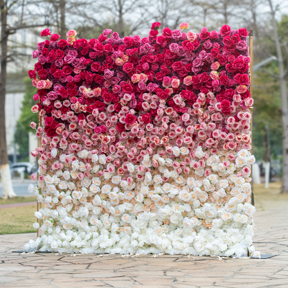 This backdrop features a dense arrangement of artificial roses in a striking gradient, transitioning from deep red at the top to soft white at the bottom. Set against an outdoor park - like backdrop, it creates a romantic and luxurious atmosphere, perfect for weddings or events. 