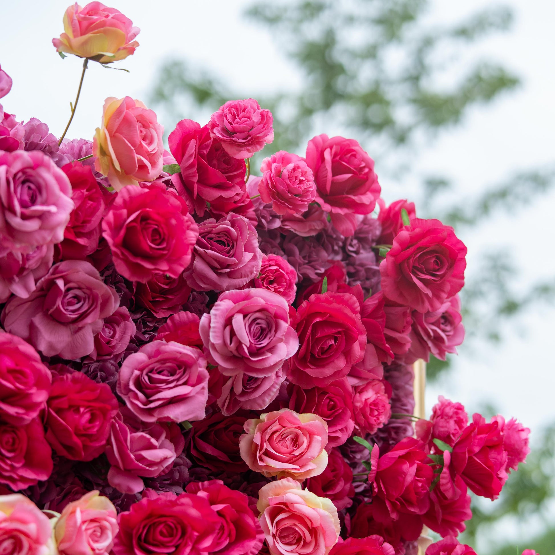 This backdrop is a lush, vibrant display of artificial roses in a rich palette of deep red and pink hues. The densely - packed blooms create a luxurious, passionate atmosphere, making it an ideal choice for weddings or high - end events. 