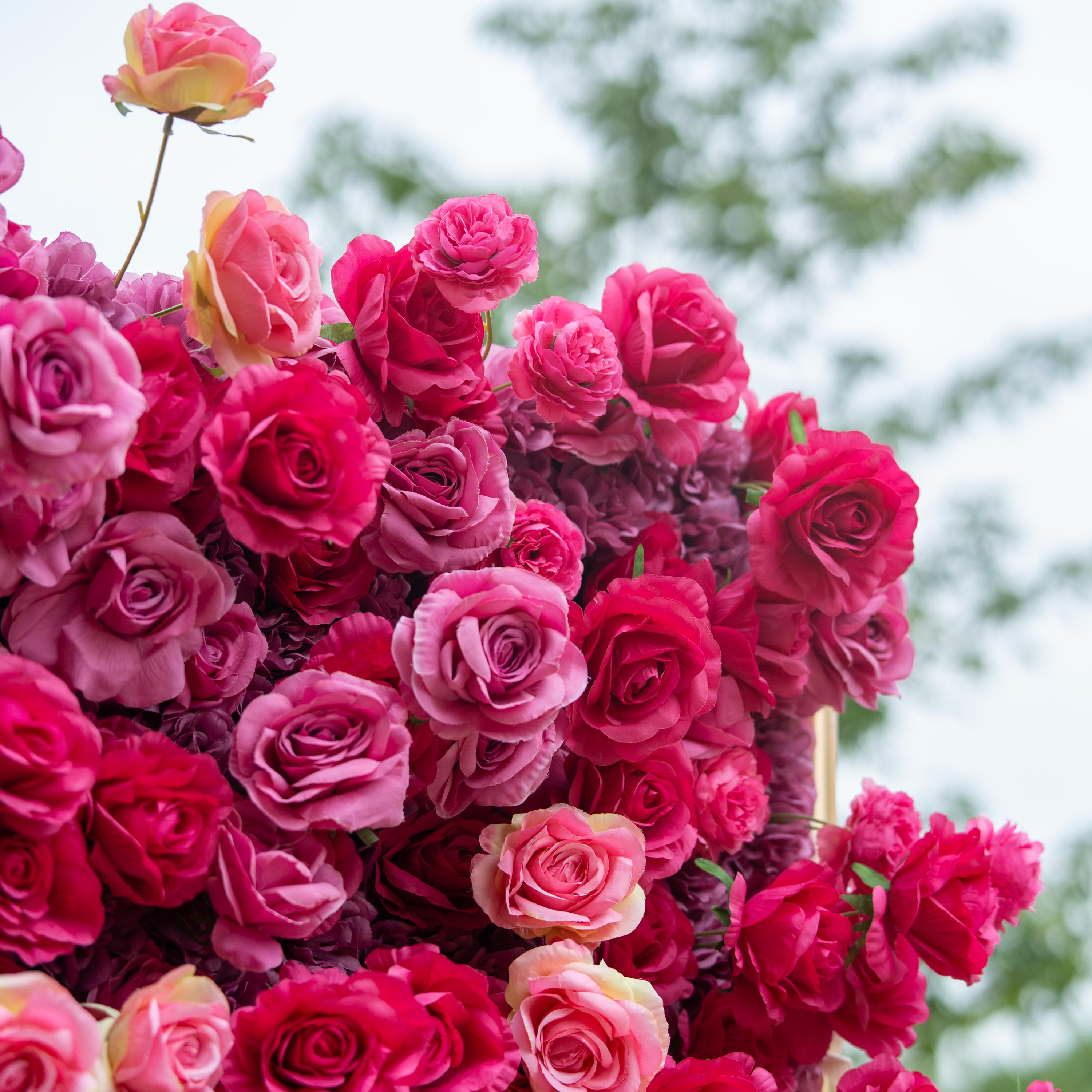 This backdrop is a lush, vibrant display of artificial roses in a rich palette of deep red and pink hues. The densely - packed blooms create a luxurious, passionate atmosphere, making it an ideal choice for weddings or high - end events. 