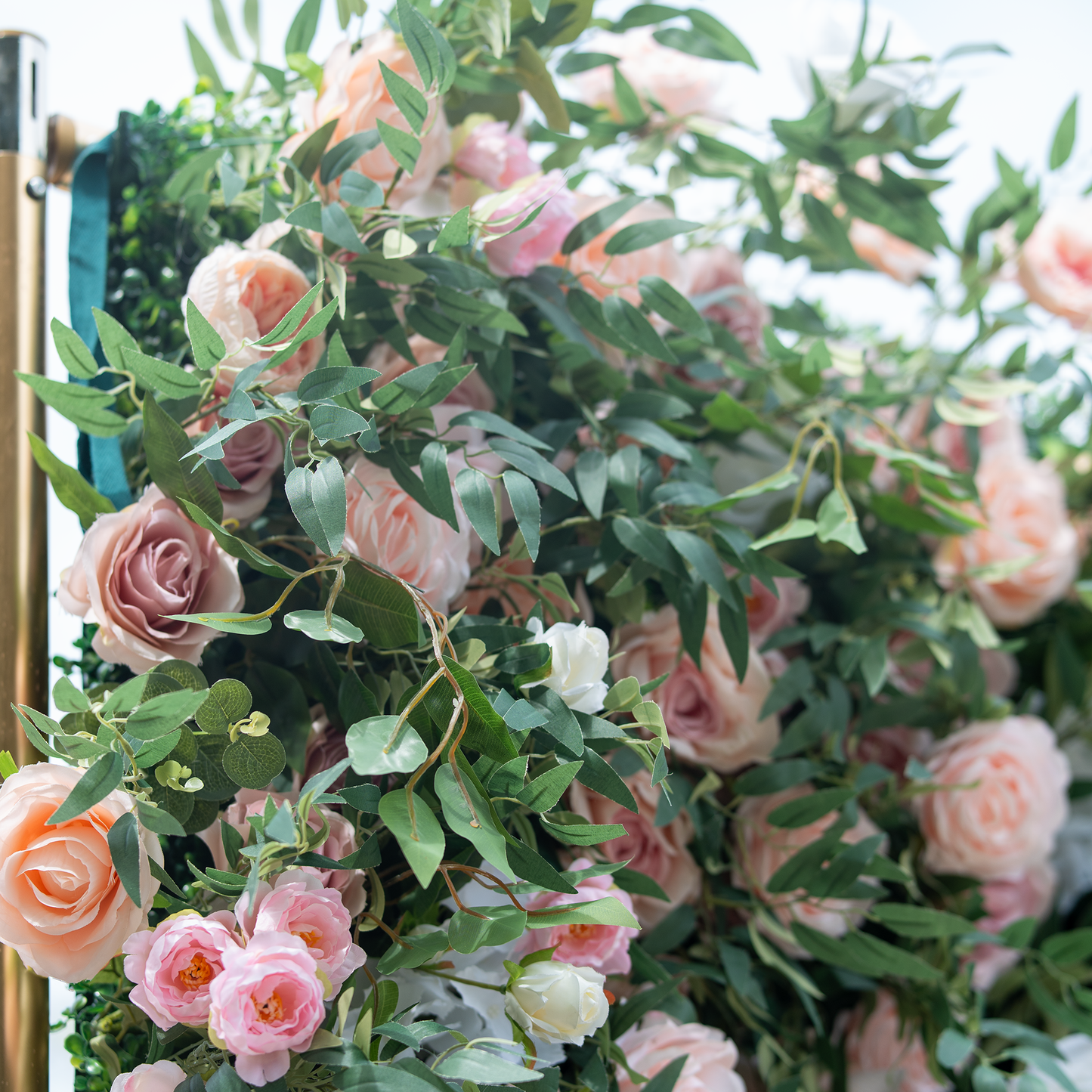 This photo features a lush arrangement of pink and white roses interwoven with green foliage, likely eucalyptus. The soft, pastel colors of the roses create a romantic and elegant atmosphere. Ideal for bridal showers or spring - inspired events, it aligns with a "Pastel Petal Party" theme. The natural - looking greenery enhances the overall aesthetic, making it a charming decorative choice for refined celebrations. 