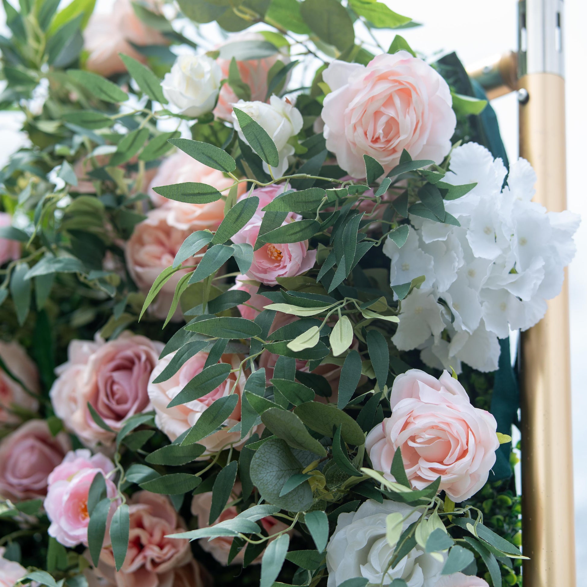 This photo features a lush arrangement of pink and white roses, along with white hydrangeas, interspersed among green foliage. The soft, pastel - colored blooms create a romantic and elegant atmosphere. Ideal for events like anniversary dinners or a "Floral Elegance Gala", it combines the charm of roses with the fullness of hydrangeas, making it perfect for refined and celebratory occasions. 