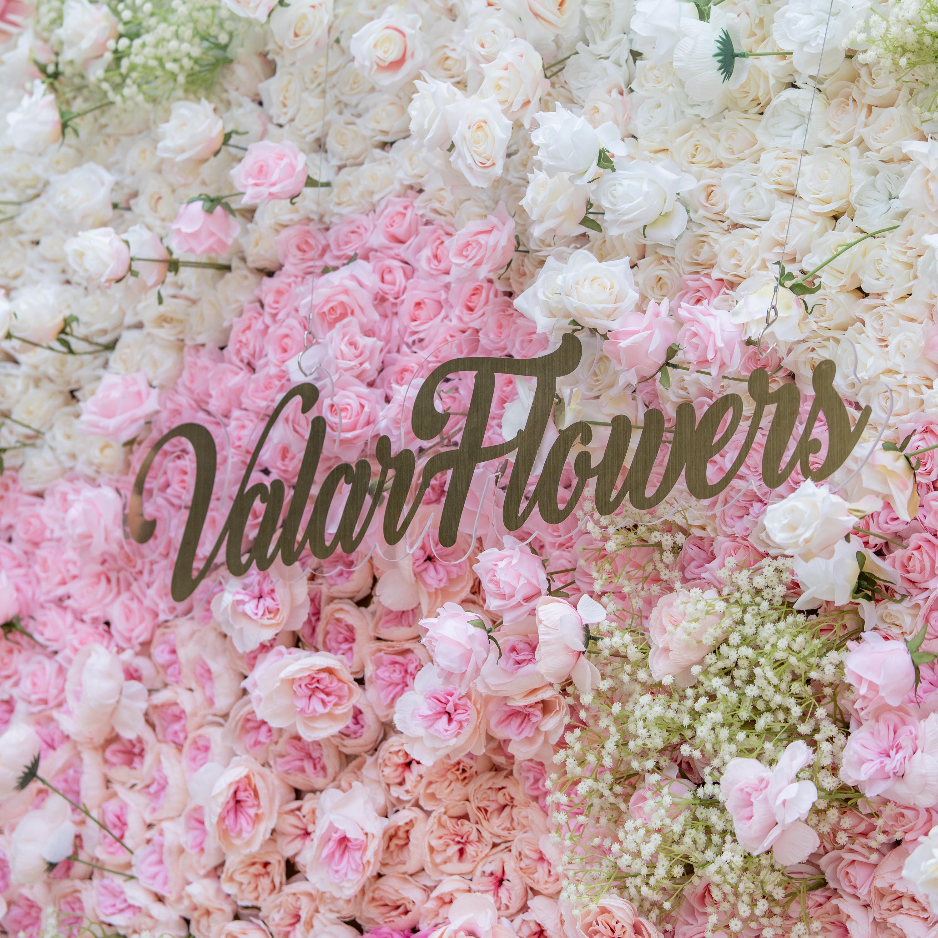 This photo showcases a lush floral display with white and pink roses, interspersed with baby&