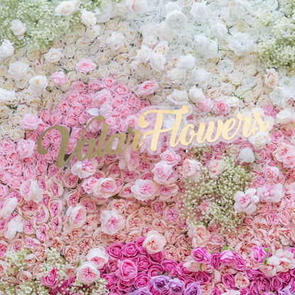 This photo features a dense floral arrangement with white and pink roses, and baby&