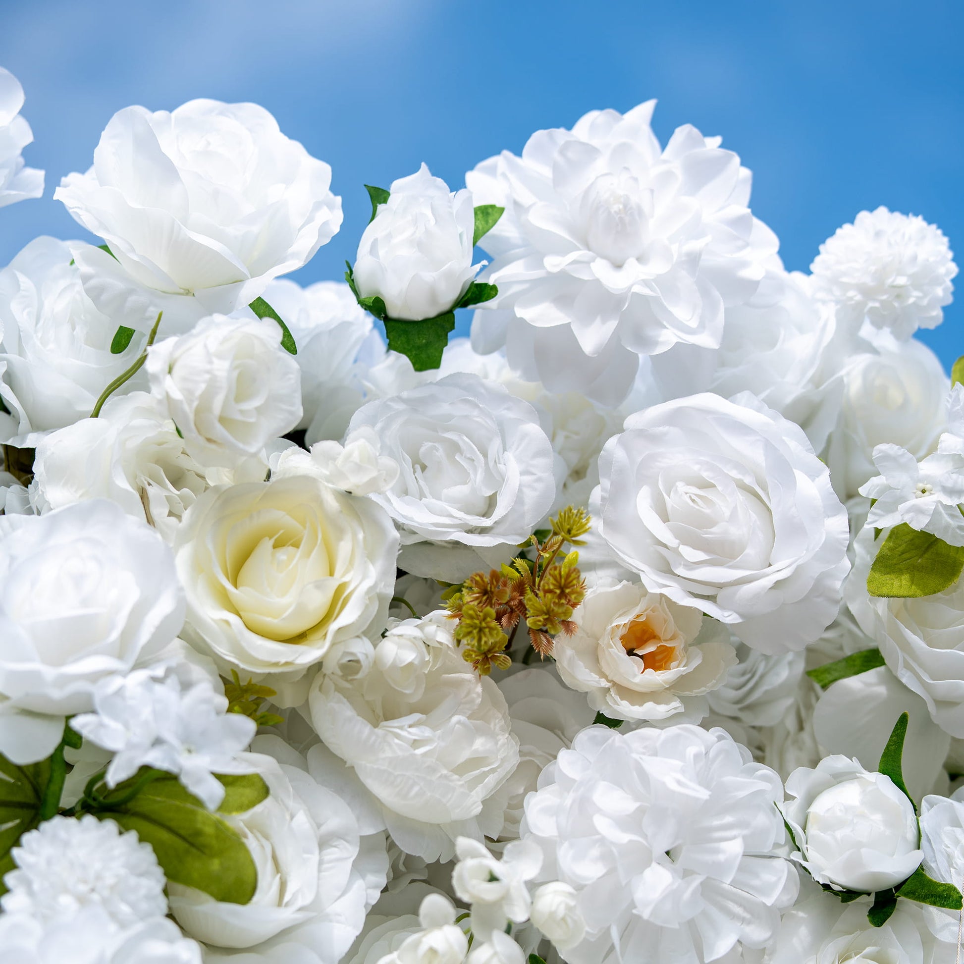 This close - up showcases a floral arrangement with predominantly white artificial roses, along with some other white flowers like peonies and small - bud blooms. Interspersed with green leaves, the color palette is a pure white accented by green. The style is elegant and clean, exuding a sense of sophistication and purity, perfect for formal events. 