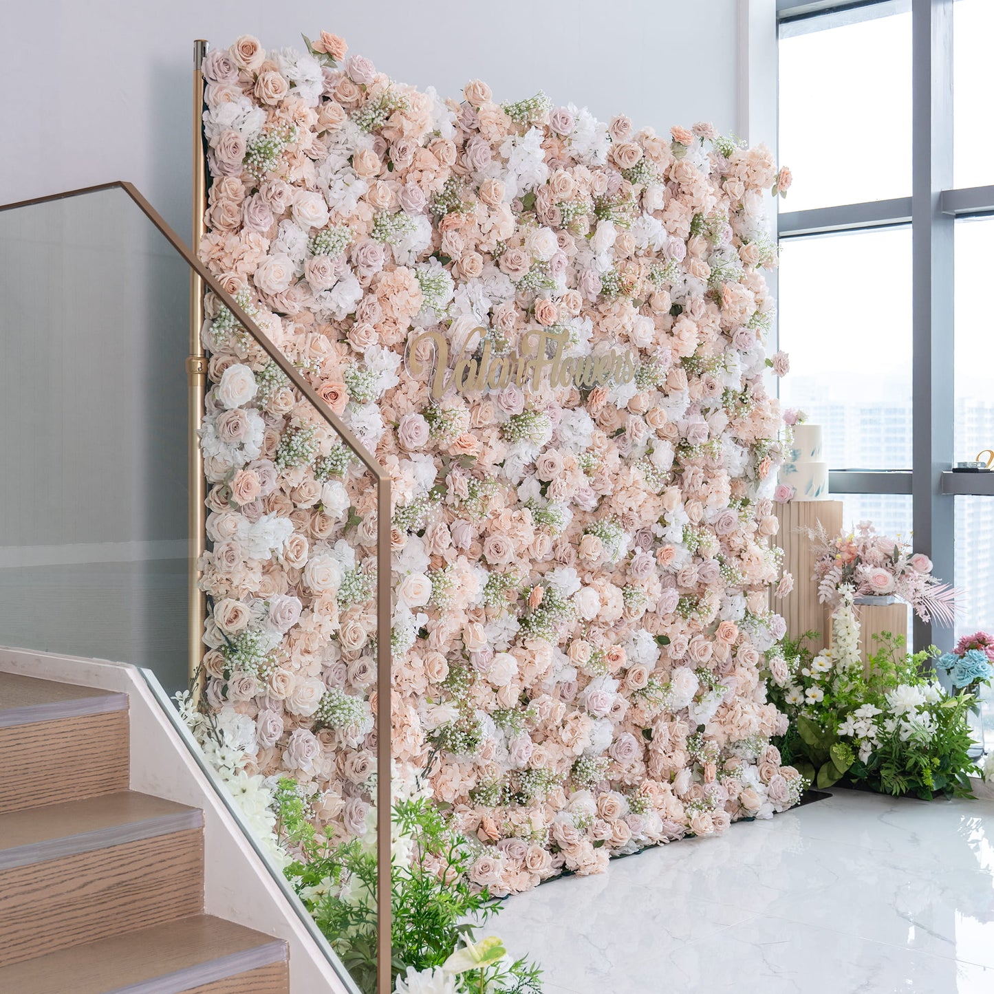 This floral backdrop is a lush, eye - catching display. It features a mix of artificial roses in soft shades of blush, cream, and white, interspersed with delicate baby's breath. The color palette is warm and neutral, creating an elegant and inviting style. Ideal for events like weddings, the backdrop adds a romantic and sophisticated touch. The "ValarFlowers" sign enhances the branding. 