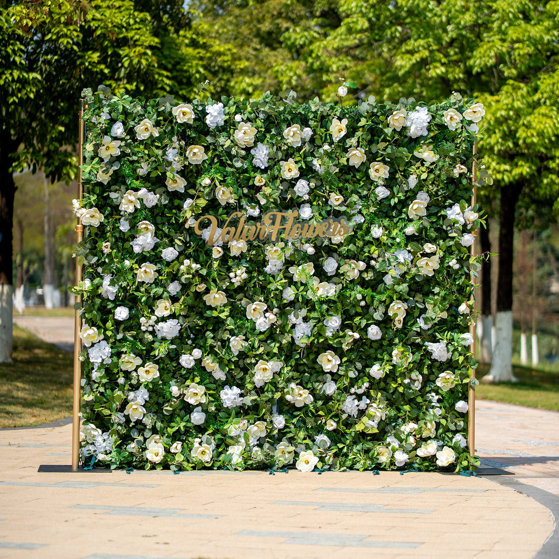 This backdrop features a lush arrangement of artificial green foliage interspersed with white flowers, including roses and camellia - like blooms. The color scheme is a fresh combination of vibrant green and pure white.
The golden - hued "Valar Flowers" sign adds an elegant touch. The overall style is natural and sophisticated, making it suitable for various events such as weddings, corporate functions, or garden parties.