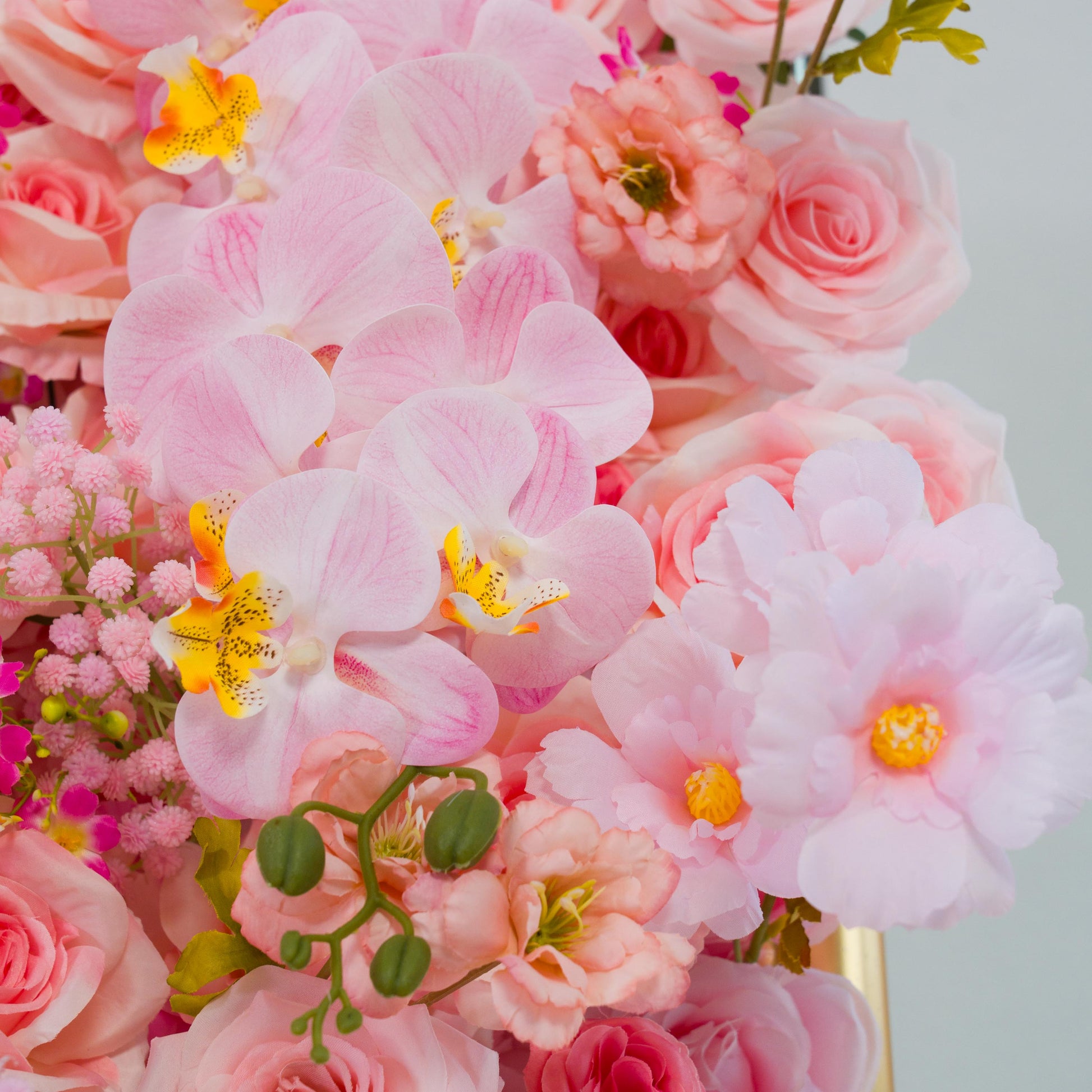 This backdrop showcases a rich arrangement of artificial flowers. Prominently featured are light - pink orchids with distinctive yellow and spotted centers, alongside various shades of pink roses. There are also soft - pink peony - like blooms and small clusters of pink filler flowers.

The color palette spans gentle pastels to slightly deeper pinks, creating a harmonious and romantic look. The overall style is elegant and inviting, perfect for events like weddings or bridal showers. 