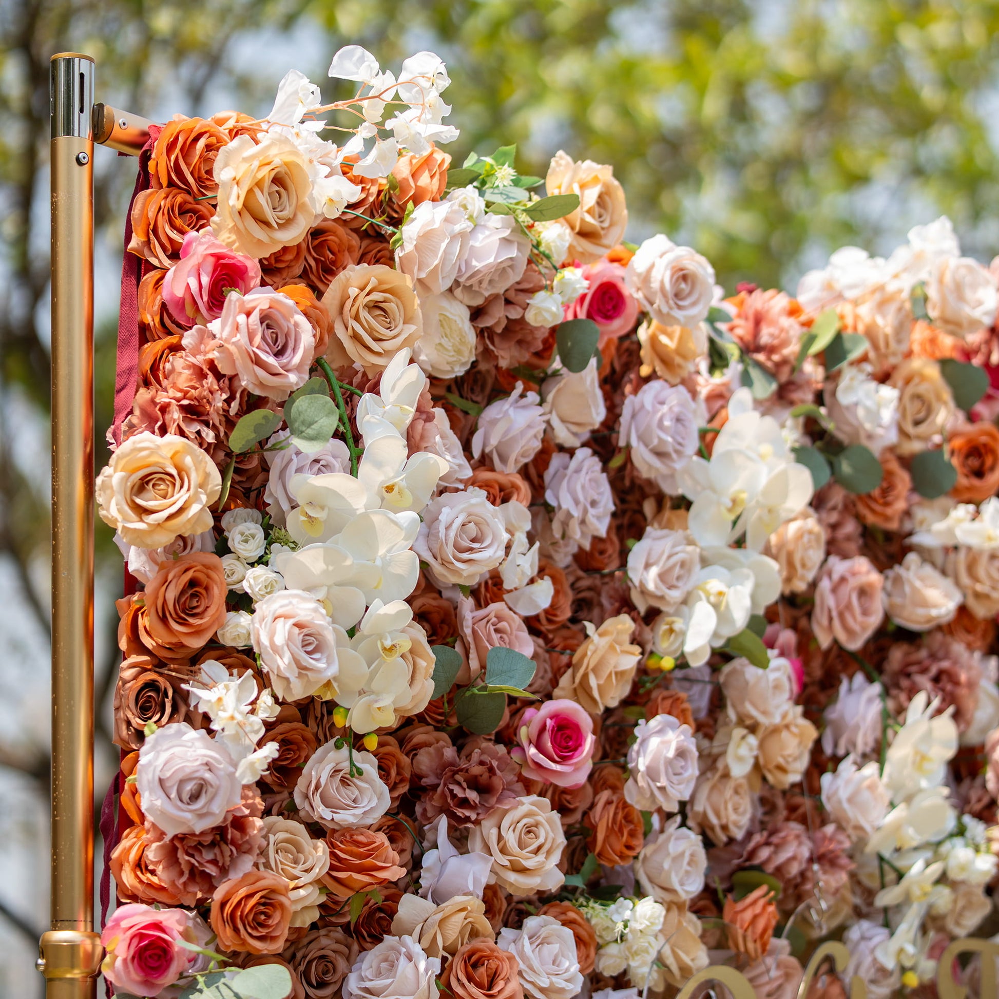 This backdrop features a warm, earthy theme color palette with shades of brown, beige, and white. It is adorned with an abundance of roses and orchids. Ideal for elegant occasions such as weddings, upscale garden parties, or refined corporate events. 
