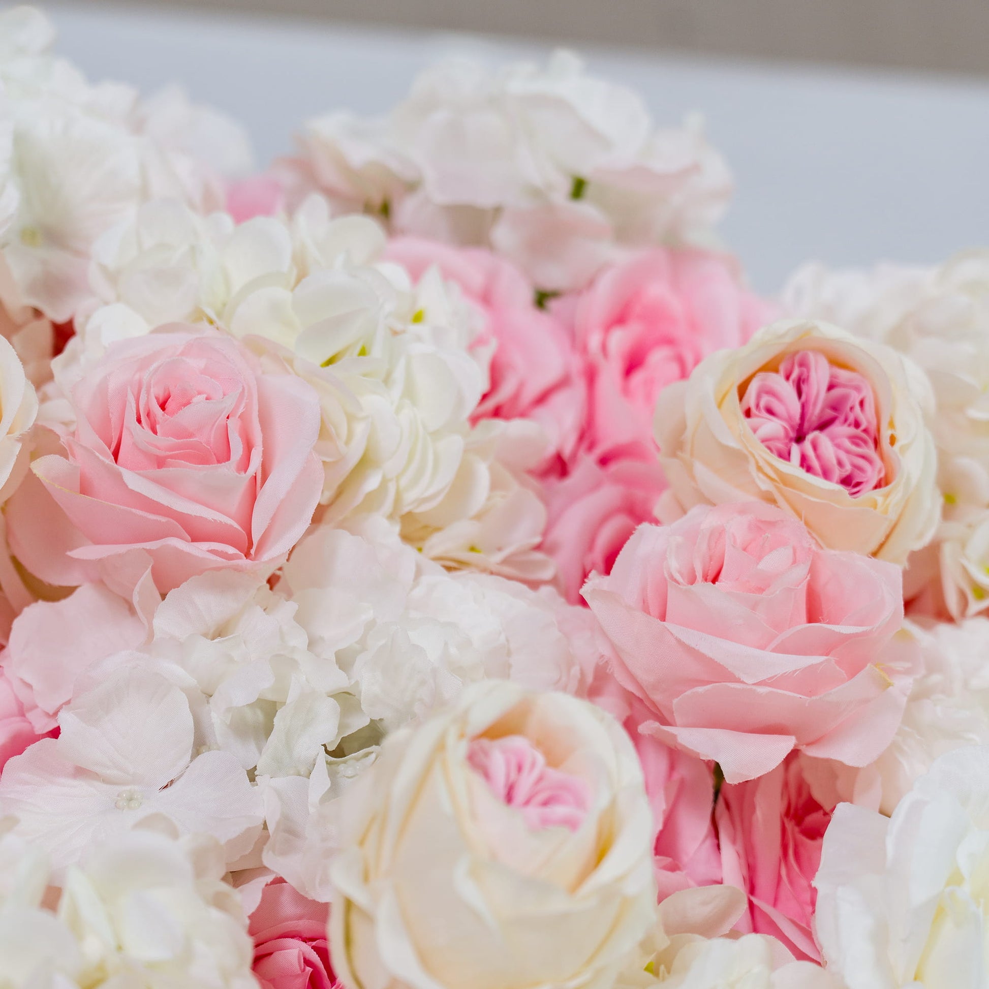 This photo showcases a lush arrangement of pink and white roses, interspersed with white hydrangeas. The soft pastel hues create a romantic and dreamy atmosphere. Ideal for weddings, bridal showers, or other love - themed events, it exudes an elegant and tender style, adding a touch of sophistication and charm to any celebration. 