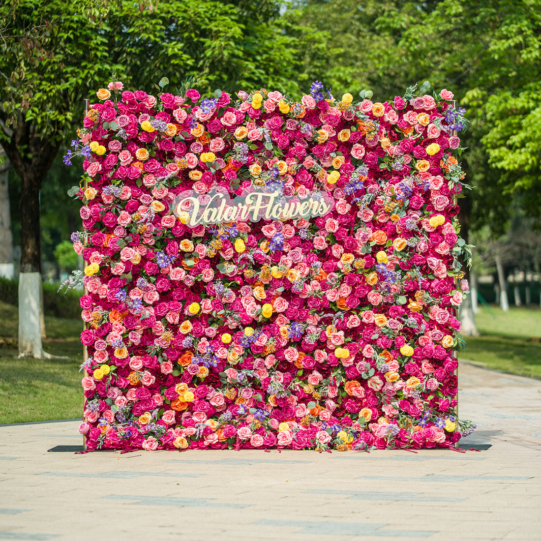 This photo showcases a vibrant floral backdrop by ValarFlowers. It&