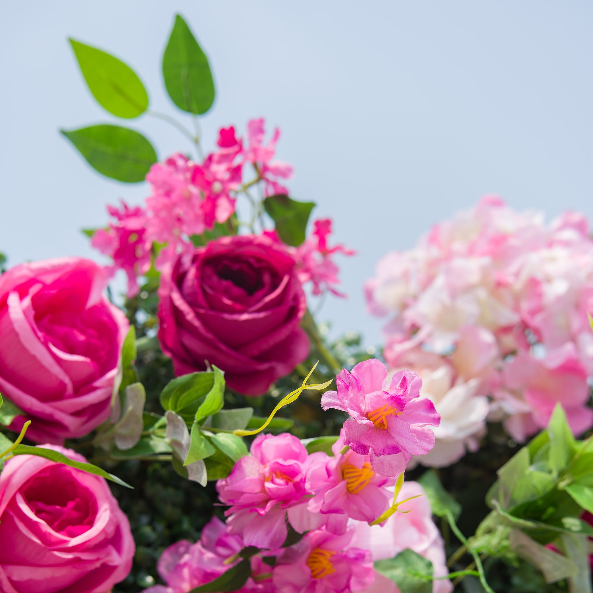 This photo showcases a vibrant floral arrangement featuring pink roses, deep - hued roses, and other assorted pink flowers, all interspersed with green foliage. The colorful blooms create a lively and romantic atmosphere. Ideal for events like a "Floral Fête in Pink" or a summer garden party, it combines the elegance of roses with a burst of color, making it a perfect decorative choice for festive and joyous occasions. 