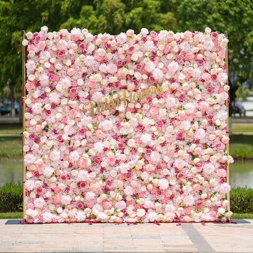 This photo from ValarFlowers showcases a large, lush floral backdrop. It is densely filled with an array of pink and white roses and peonies, creating a soft and romantic atmosphere. The backdrop is framed by golden poles, adding a touch of elegance. Ideal for weddings, bridal showers, or a “Blossoming Love” - themed event, it serves as a beautiful decorative element, exuding charm and grace. 