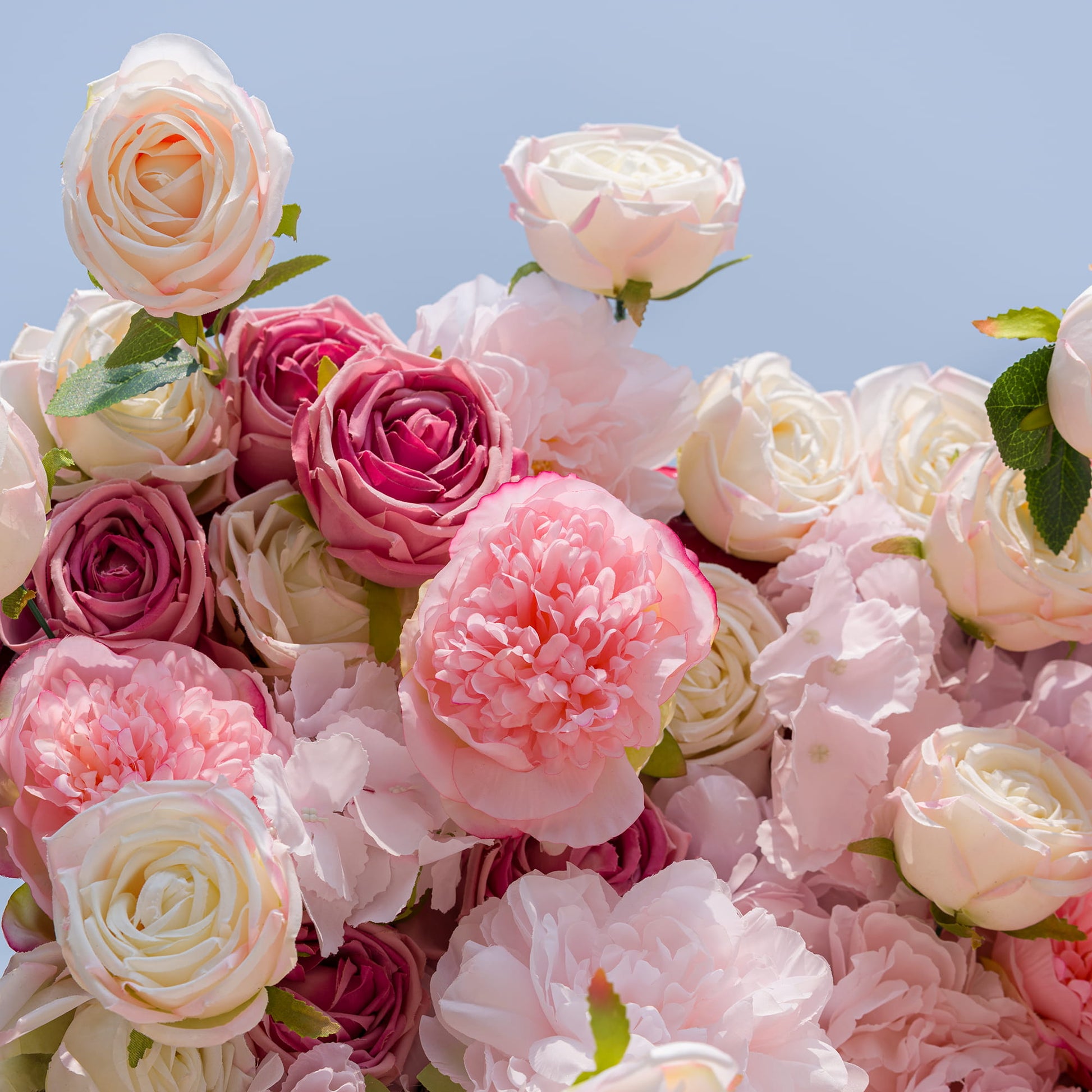 This photo from ValarFlowers showcases a lush cluster of roses and peonies in various shades of pink and cream. The soft, delicate petals create a dreamy and romantic look. Ideal for weddings, engagement parties, or anniversary celebrations, these flowers add an elegant and charming touch. Their beauty makes them perfect for any event centered around love and celebration. 