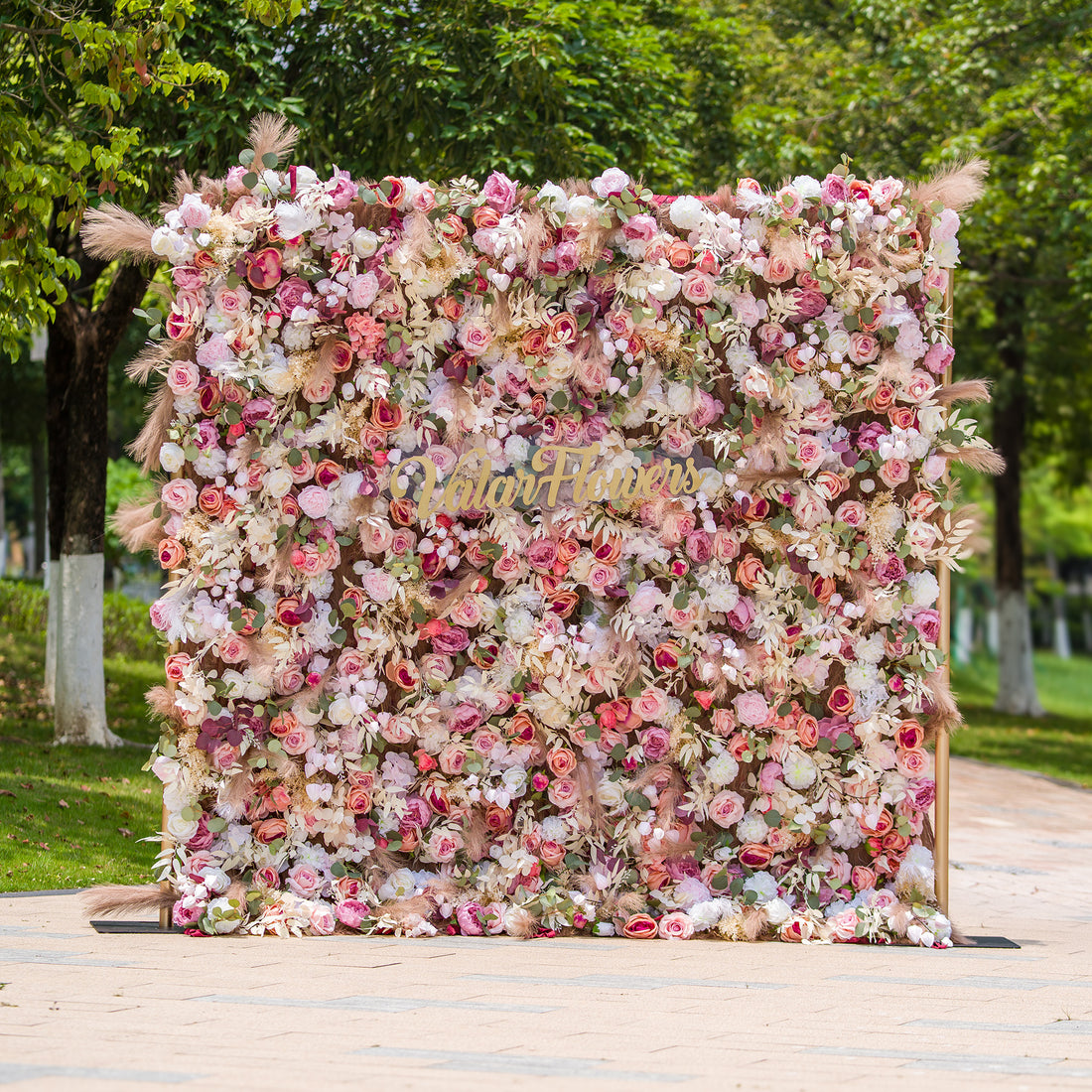 This photo showcases a 2.4x2.4m floral backdrop made by ValarFlowers, densely packed with an array of roses, peonies, and other blooms in soft pinks, whites, and hints of peach. Interspersed with green foliage and pampas grass, it exudes a romantic and elegant vibe. Ideal for events such as a “Romantic Blush” wedding or a spring - themed garden party, it creates a dreamy atmosphere.
