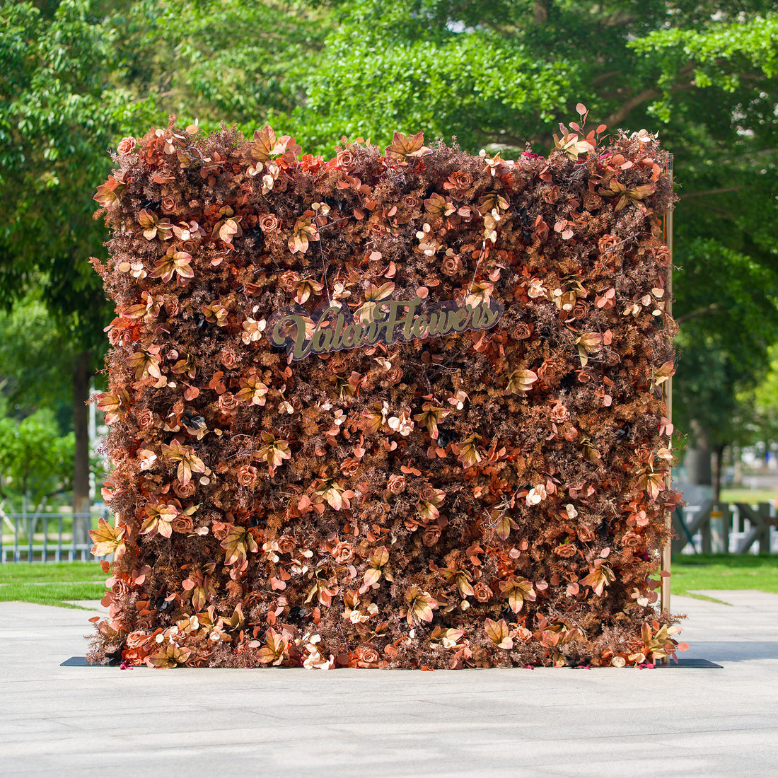 This photo features a dense floral backdrop composed of various autumn - hued flowers and foliage in shades of brown, rust, and copper. The text “ValarFlowers” is prominently displayed. Ideal for events like an “Autumn Harvest” wedding or a fall - themed gala, it exudes a warm, rustic charm perfect for seasonal celebrations. 