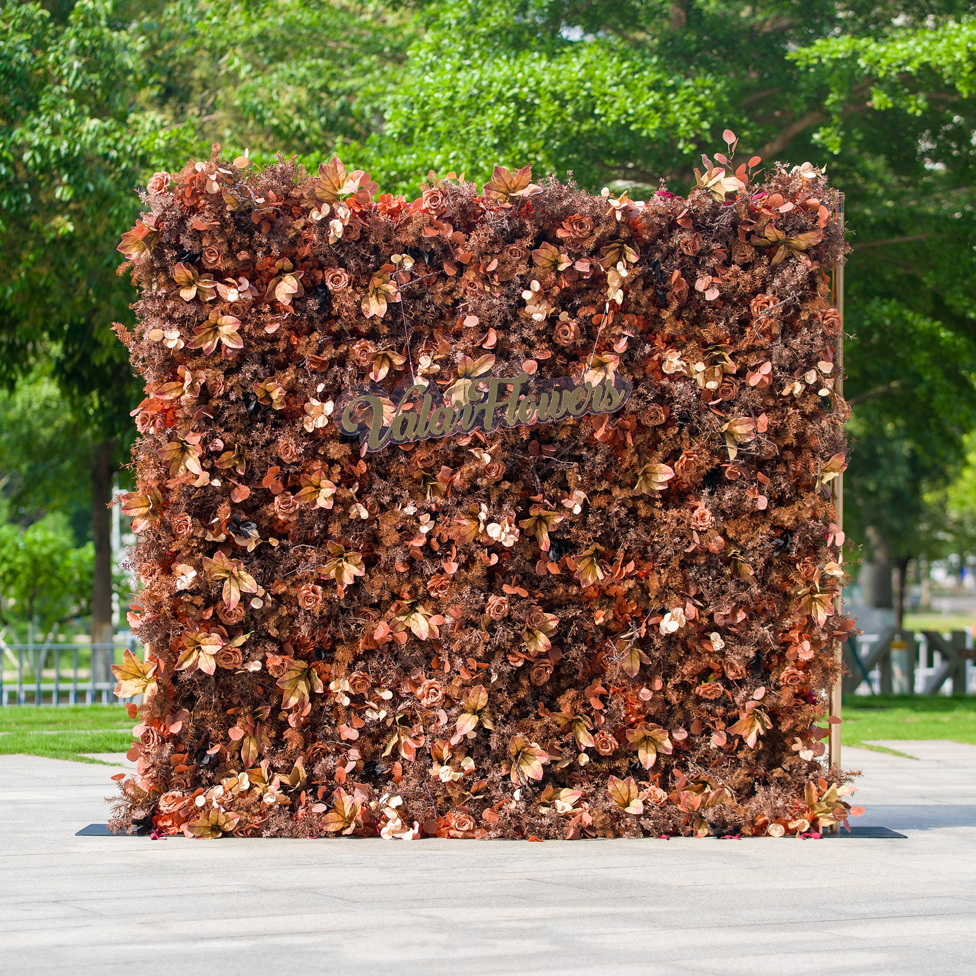 This photo features a dense floral backdrop composed of various autumn - hued flowers and foliage in shades of brown, rust, and copper. The text “ValarFlowers” is prominently displayed. Ideal for events like an “Autumn Harvest” wedding or a fall - themed gala, it exudes a warm, rustic charm perfect for seasonal celebrations. 