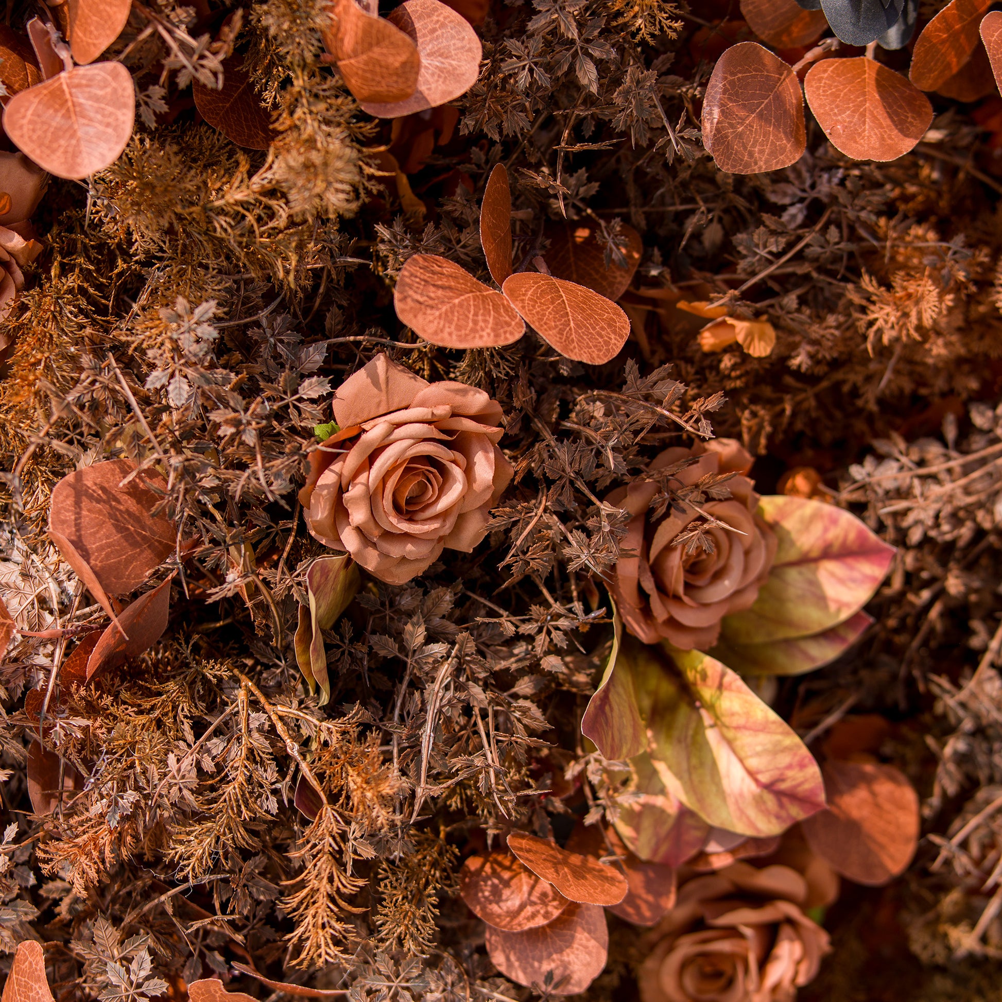This photo showcases a lush arrangement of autumn - hued roses and various foliage in rich brown, rust, and copper tones. The blooms and leaves create a warm, textured display. Ideal for events like an “Autumn Elegance” wedding or a harvest - themed party, it exudes rustic charm, perfect for seasonal celebrations. 