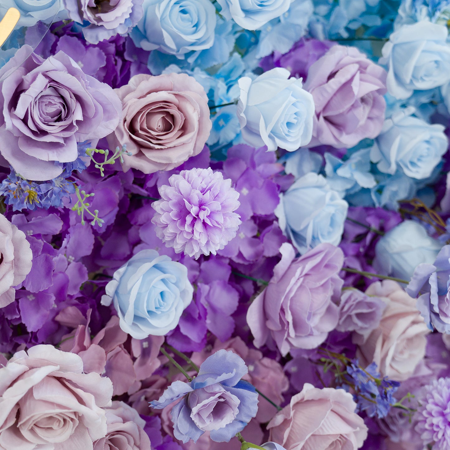 This vibrant floral arrangement features a mix of roses, chrysanthemums, and small blue blossoms. The color theme blends soft lavender, pale pink, and light blue, creating a dreamy, romantic vibe. Perfect for weddings, bridal showers, or upscale events, the pastel hues and varied flower types work together to form an eye - catching, elegant backdrop ideal for memorable photo moments. 