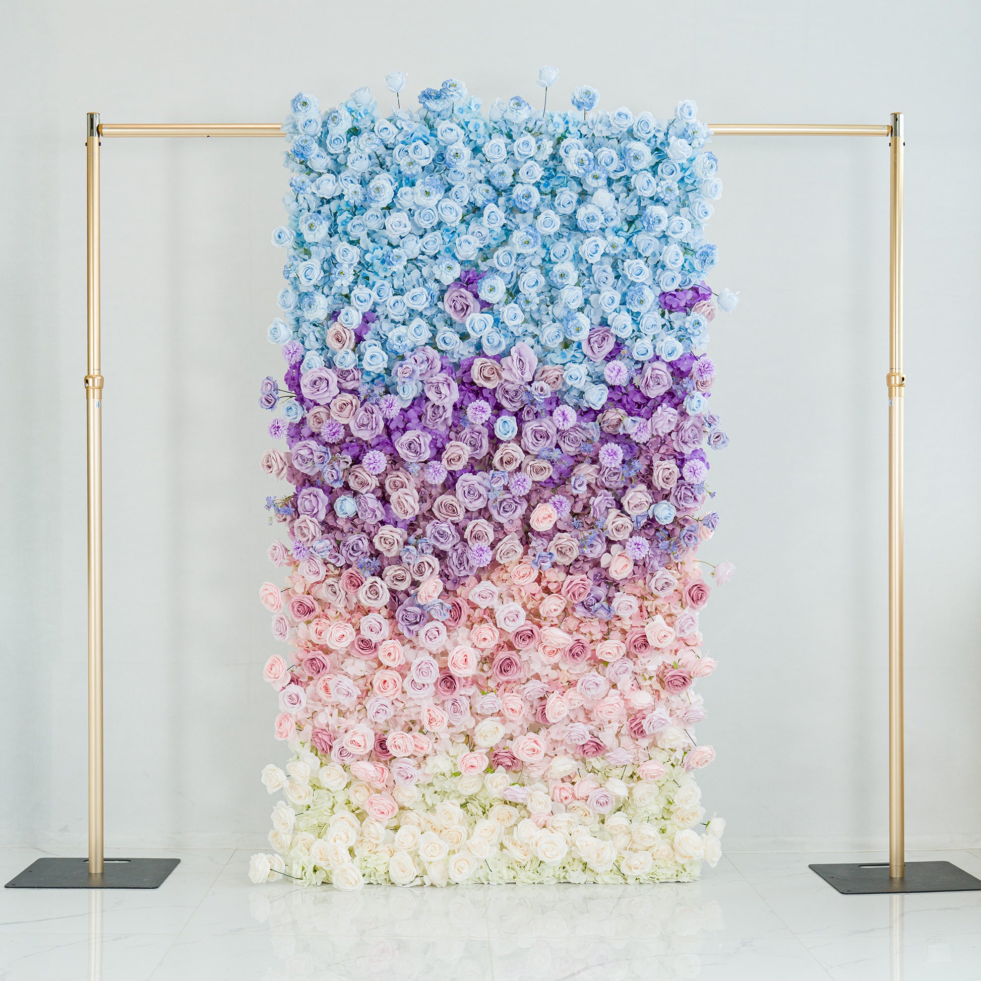 This stunning floral backdrop features a gradient of roses in hues of blue, purple, pink, and white. The ombre color theme, transitioning smoothly from sky - blue at the top to soft white at the base, creates a dreamy, elegant vibe. Framed by gold poles, it’s perfect for weddings, galas, or upscale events, serving as a sophisticated, photo - worthy centerpiece that blends natural beauty with polished design. 