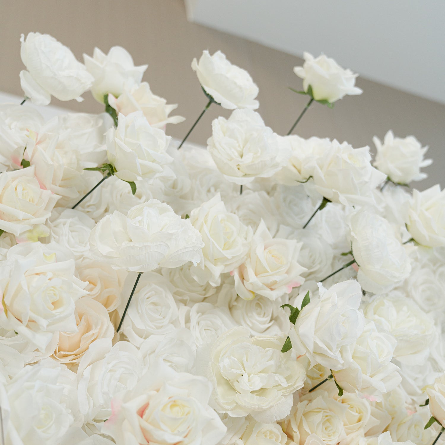 A lush arrangement of white roses, their petals soft and pristine. These artificial flowers create a pure, elegant color theme—ideal for weddings, bridal showers, or formal events. The monochromatic white exudes timeless romance and sophistication, perfect for backdrops, decor, or centerpieces needing a classic, refined touch. 