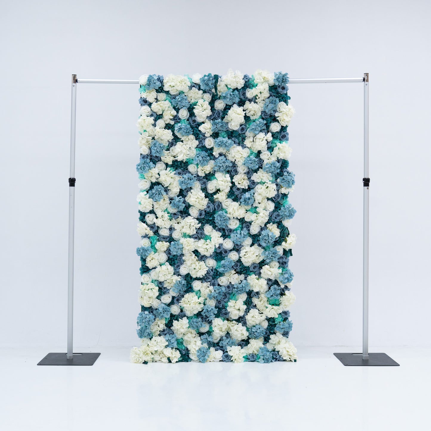 This 4x8ft flower wall from Valar Flowers is a stunning display of artificial roses in white and various shades of blue. The dense arrangement creates a visually appealing and vibrant backdrop, perfect for weddings, photo shoots, or other special events with a blue and white color theme. The meticulous arrangement of the roses enhances the overall aesthetic, adding a touch of sophistication and natural beauty to any setting. 