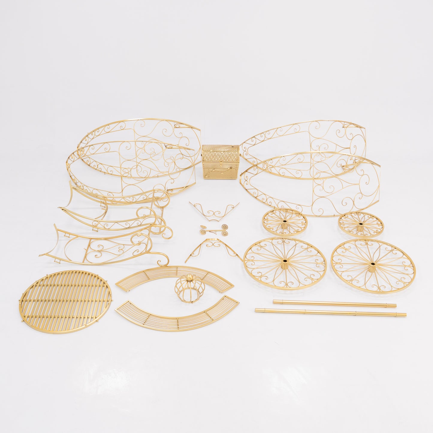 Unassembled parts of a golden, ornate Cinderella - style carriage. Features intricate wrought - iron scrollwork for the frame, wheels, and decorative elements, plus a latticework trunk. Perfect for building a fairy - tale - themed display, showcasing detailed craftsmanship. 
