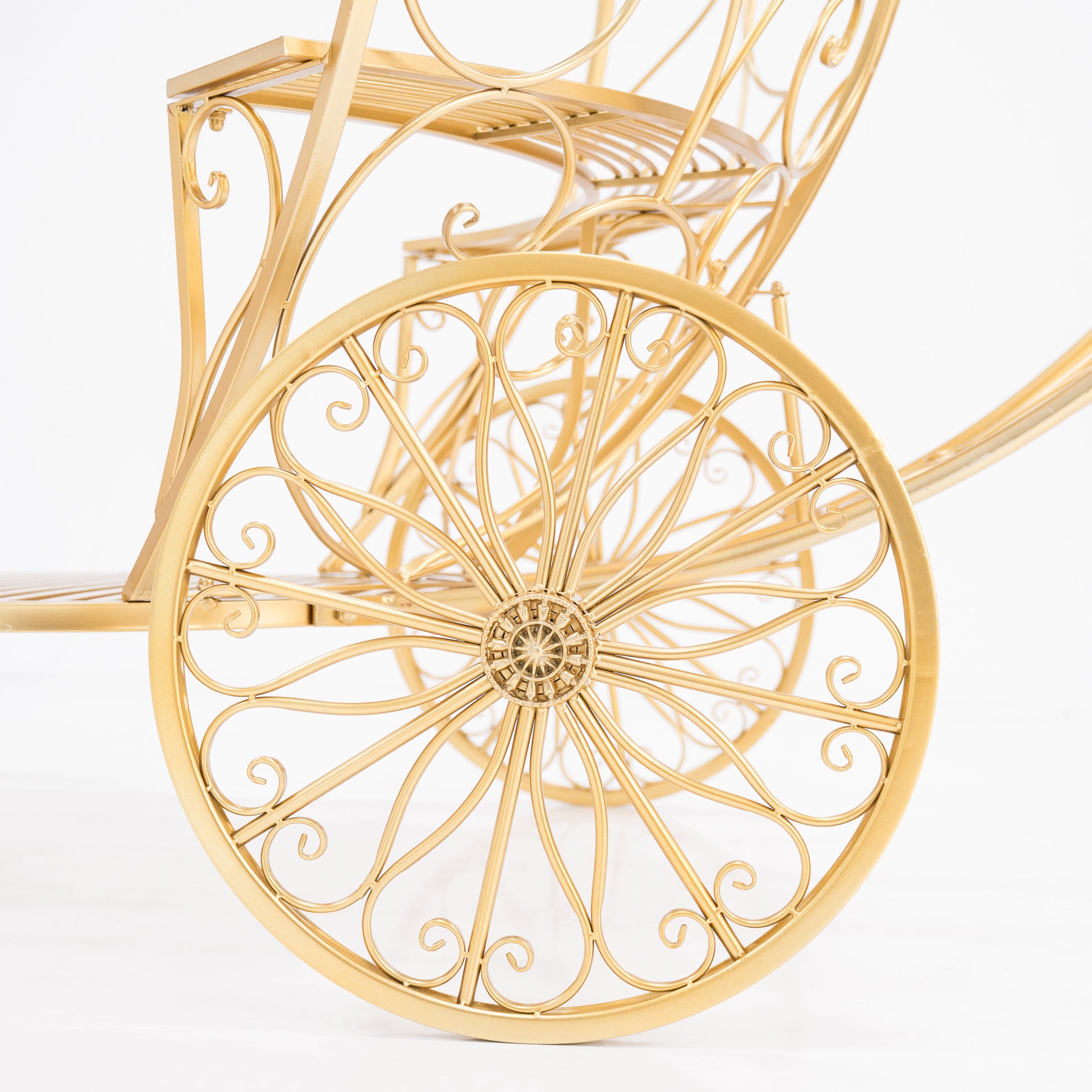 A close - up of a golden, ornate wheel from a Cinderella - style carriage. Intricate scrollwork and a decorative hub showcase elaborate wrought - iron design. The shimmering gold finish adds fairy - tale charm, perfect for themed displays. 