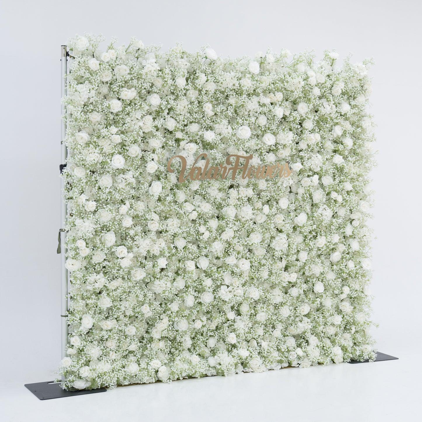 This image features a large, square floral wall densely covered with white flowers, including baby's breath and small blooms. "Valar Flowers" is displayed in elegant, golden text. Set against a plain white background, the wall exudes a pure, elegant, and refined atmosphere, perfect for decorative purposes in events or as a stylish backdrop, highlighting the beauty and craftsmanship of Valar Flowers.