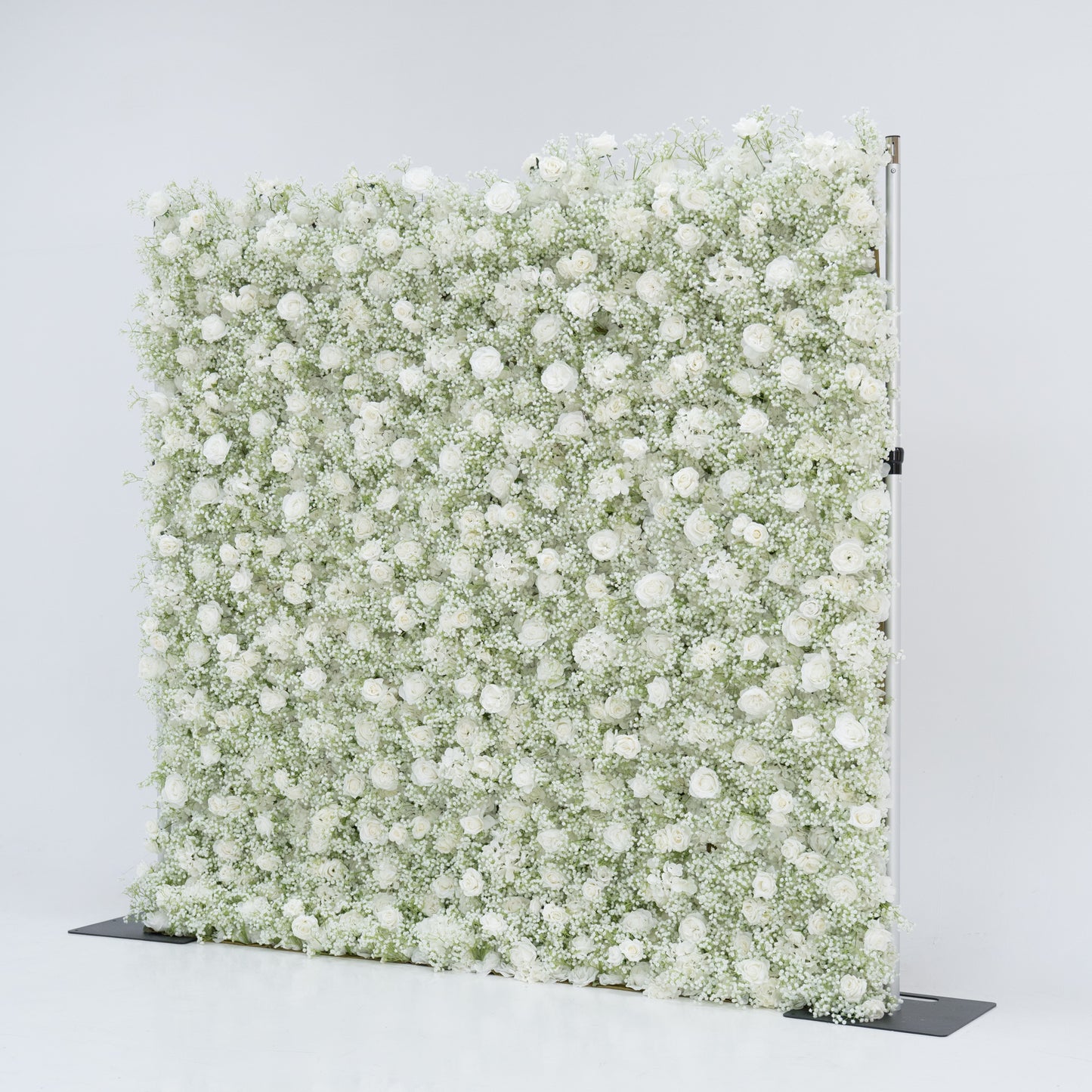 This image showcases an 8x8ft floral wall by Valar Flowers, densely adorned with white roses and baby's breath. The lush, pure white blooms create a stunning, elegant, and serene visual. Set against a plain white background, the wall exudes a sense of sophistication and natural beauty, perfect for decorative use in events or as a stylish backdrop, highlighting the brand's craftsmanship and the delicate allure of the floral arrangement.