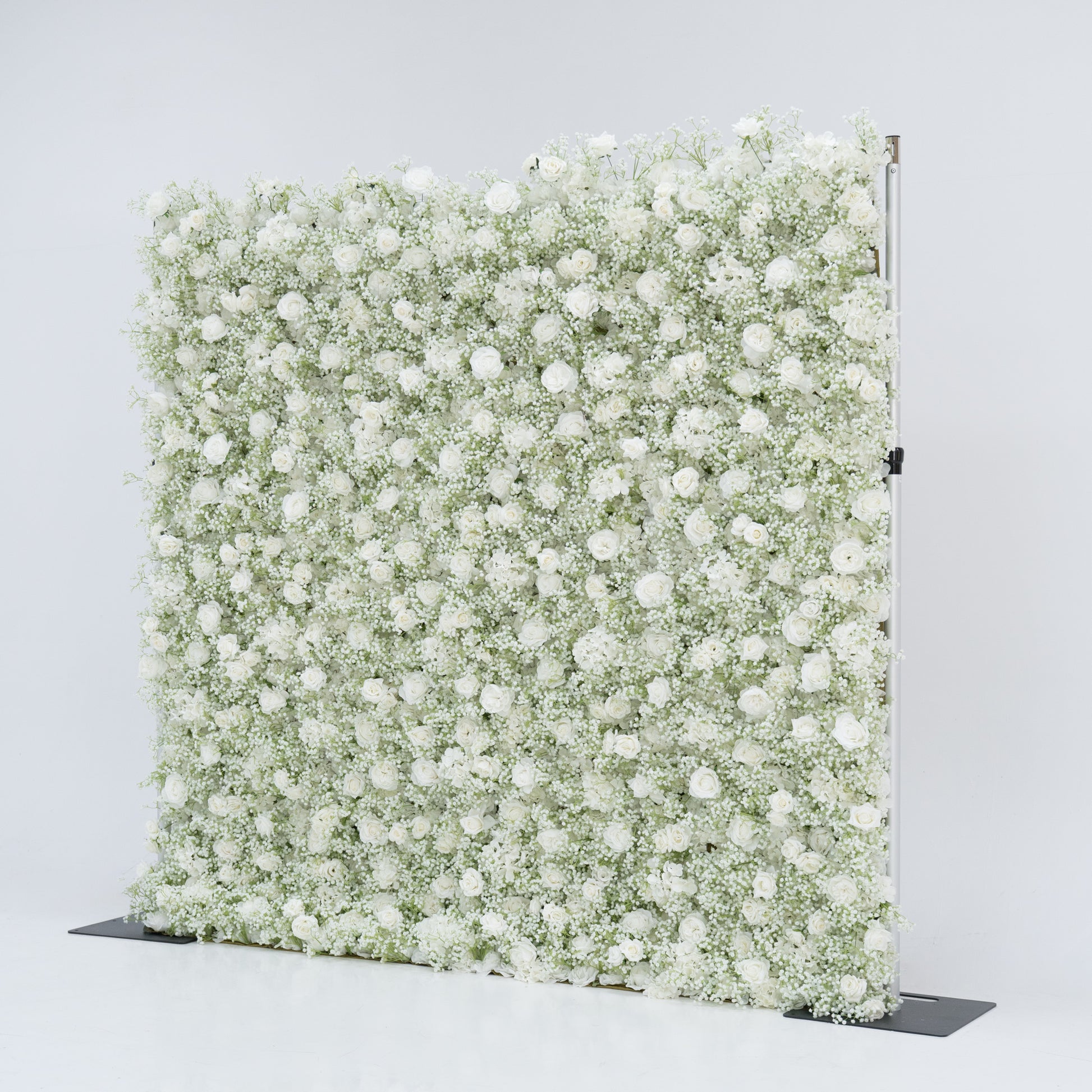 This image showcases an 8x8ft floral wall by Valar Flowers, densely adorned with white roses and baby's breath. The lush, pure white blooms create a stunning, elegant, and serene visual. Set against a plain white background, the wall exudes a sense of sophistication and natural beauty, perfect for decorative use in events or as a stylish backdrop, highlighting the brand's craftsmanship and the delicate allure of the floral arrangement.