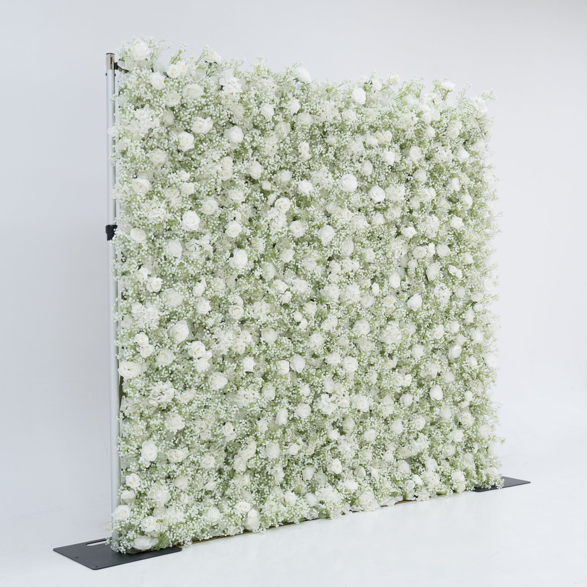 This image displays an 8x8ft floral wall by Valar Flowers, densely covered with white roses and baby's breath. The lush, pure white blooms create a stunning, elegant, and serene visual. Set against a plain white background, the wall exudes a sense of sophistication and natural beauty, perfect for decorative use in events or as a stylish backdrop, highlighting the brand's craftsmanship and the delicate allure of the floral arrangement.