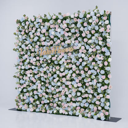This image showcases a vibrant floral backdrop by Valar Flowers, set against a plain white indoor background. It features a dense arrangement of artificial flowers in various shades of blue, light blue, and pink, with the brand’s name elegantly integrated in gold. Exuding elegance, it’s perfect for adding a sophisticated, nature-inspired element to events or interiors, highlighting Valar Flowers’ craftsmanship in detailed, eye-catching decor.
