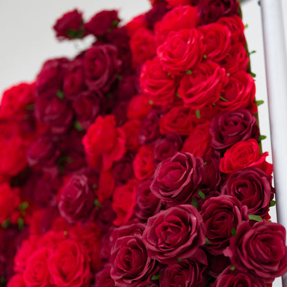 This lush close-up bursts with a dense cluster of red roses, blending vivid crimson and deep burgundy hues. Their soft, ruffled petals create a velvety, romantic texture, filling the frame with rich, warm depth. The layered blooms exude passion and elegance, making this display ideal for romantic event decor, wedding styling, or intimate floral accents.